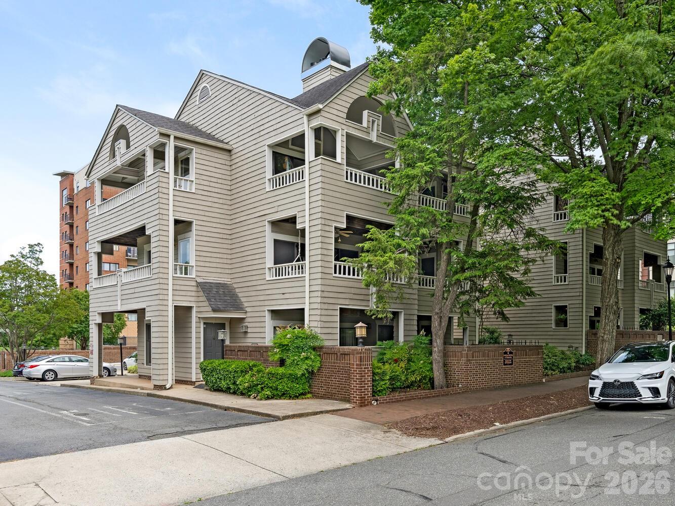 Must-see updated penthouse in historic Fourth Ward! This tranquil corner unit w/ 300 sq ft of covered outdoor space has panoramic sunset views overlooking mature trees. Gorgeous kitchen features marble waterfall countertop/backsplash w/ Sub-Zero under-cabinet fridge & freezer drawers, Wolf & Cove stainless steel appliances. Newer light LVP flooring. Bathroom updates include deep soaking Jacuzzi tub /shower. Primary bedroom has built-in corner vanity w/ LED lighting & upgraded closet system. Vaulted 12-foot living room ceiling creates a treehouse effect through sliding doors onto a private covered porch w/ storage closet. One of only two units in the complex with a private landing outside the front door; 3 sides of windows and only one small party wall make the space quiet & light-filled. 18-unit Barringer Square is just a few blocks from Center City/ the light rail, next door to Spaghett and just a block away from the planned new Publix!