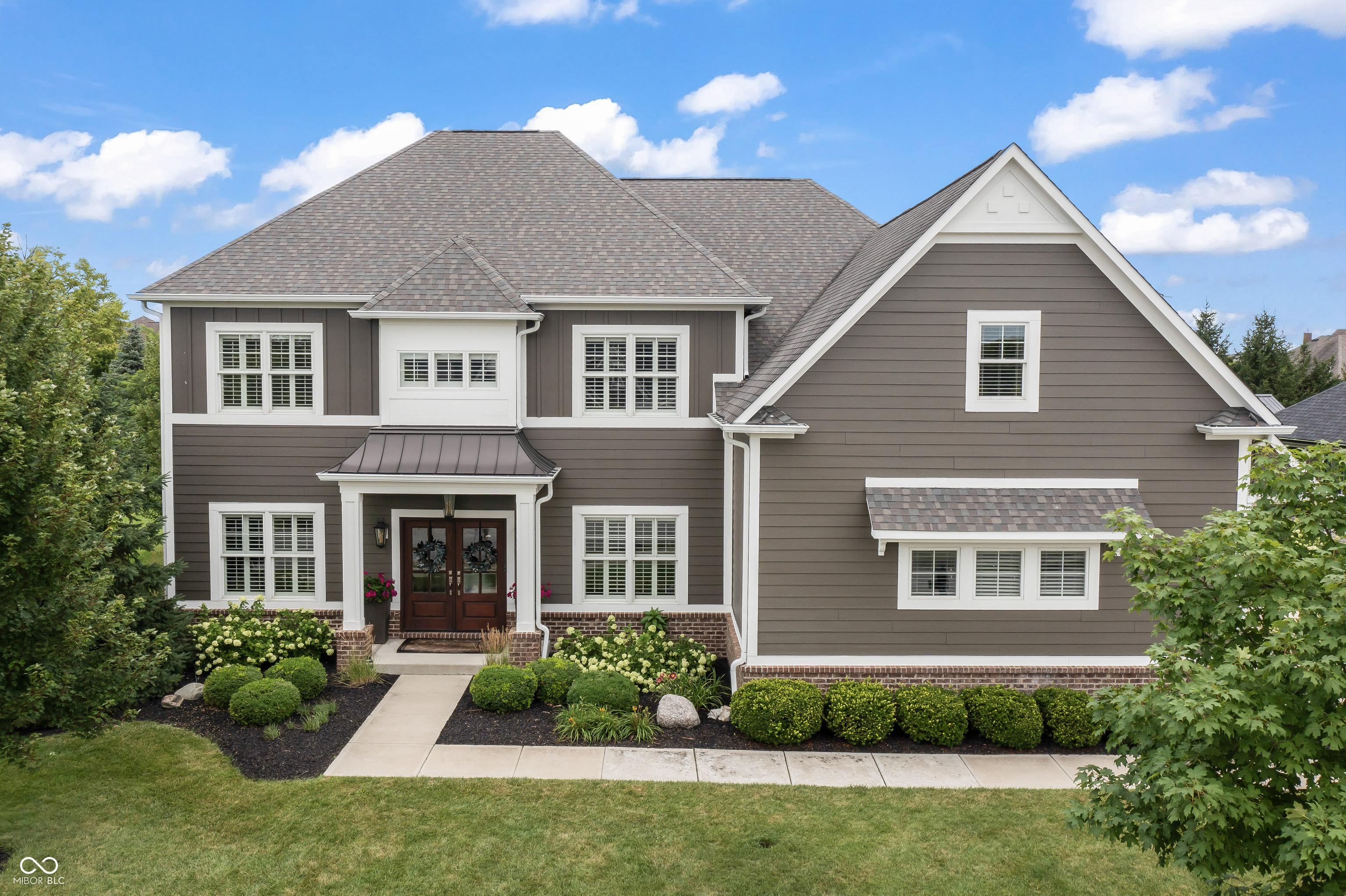 Step into luxury with this exquisite 5-bed, 4.5-bath custom home by Gradison Design-Build i boasting almost 6000 square feet of meticulously finished space in the coveted Timberstone neighborhood. As you enter, you're welcomed by a spacious foyer that sets the tone for the character & custom details throughout the home.  For those who work remotely, the den at the front of the home offers the perfect private retreat. The great room, featuring a cozy gas fireplace & custom built-ins, seamlessly connects to the gourmet kitchen & eating area, creating an inviting space for both everyday living & entertaining.  Culinary enthusiasts will appreciate the kitchen's expansive granite countertops, sleek stainless steel appliances & convenient bar seating. A butler pantry/wine bar enhances this home's entertaining capabilities, ensuring you have everything needed for hosting in style.  Completing the main level is a sunroom, ideally situated off the kitchen. This bright an& airy space is perfect for relaxation, whether you're starting your day with a cup of coffee or unwinding in the evening.  The upper level includes the primary suite, complete with a large walk-in closet & a spa-like bath featuring double sinks & a walk-in shower. Granite tops add a touch of elegance to the room. Bedrooms three & four are enhanced by a Jack-and-Jill bath, while bedroom four offers its own bath. The laundry room is also conveniently located on this level. Additionally, the upstairs bonus room provides versatile space for a TV room, game room, or craft area-your choice!  The finished basement with an additional bedroom & full bath adds extra living space, perfect for entertainment, a home gym, or a cozy retreat. The backyard is an entertainer's dream, featuring a large paver patio & custom fireplace, perfect for gatherings. The oversized three-car garage offers ample space for parking & storage.  Discover the perfect blend of luxury, comfort & functionality in this stunning home. HSE School