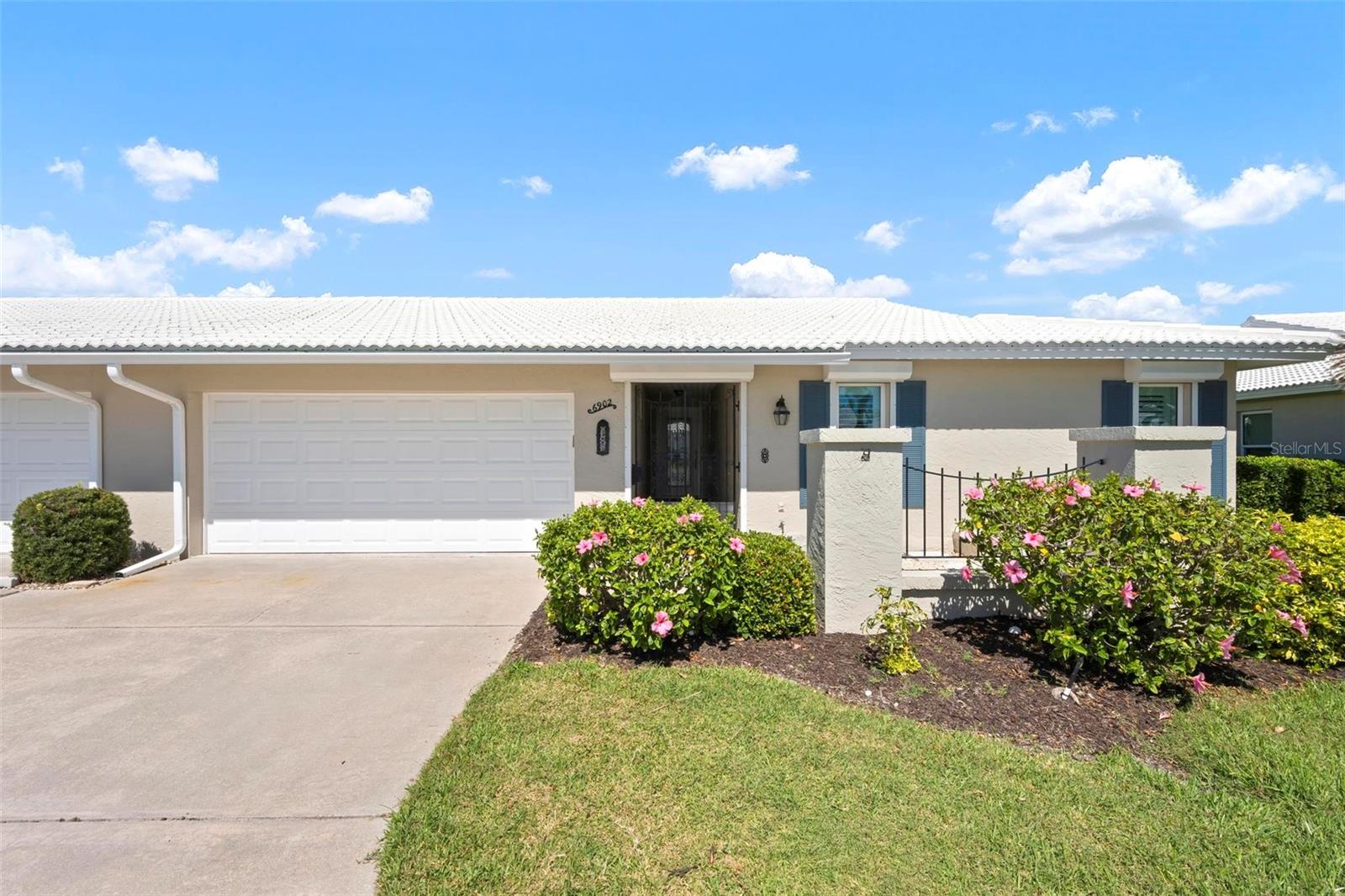 One or more photo(s) has been virtually staged. MOVE IN READY, UPDATED, HURRICANE REINFORCED, FLOOD ZONE X! (No Flood Ins Required) It does not get better than this! Located on a quiet cul-de-sac, this 55+ community of Village Green is appropriatelynamed for its uniquely generous GREEN SPACE right outside your back door, encirclingyour private community pool &amp; cabana.This beautifully updated 2BR 2Bath home features a large open spacious floor plan withsophisticated finishes, recessed lighting, ceiling fans, plantation shutters, and luxurywood grain vinyl flooring throughout.The custom-designed kitchen is complete with soft close cabinets featuring roll-outshelves, deep drawers, granite countertops, tile backsplash, stainless-steel appliancesand a Culligan reverse osmosis system for purified water at the kitchen sink and icemaker. The master bedroom with ensuite offers a unique walk-in custom spa shower. A dedicated laundry room includes a front-load washer and dryer, a utility sink for addedconvenience and lots of additional space for a personal office or pantry.  Built for Floridaliving, recent upgrades included impact windows and doors supported by additionalrolldown and metal panel shutters providing comprehensive storm protection. Theoversized two-car garage includes shelf storage and attic storage accessible by drop-down stairs and a 2nd utility sink for convenience.This section of Village Green boasts the lowest HOA fees of all sections. Qtrly HOA feesinclude landscape and irrigation service as well as basic cable/internet, exterior painting,annual roof cleaning, exterior pest control, pool upkeep, common area taxes, escrowreserve.  Centrally located in Bradenton, and under 10 minutes from gulf coast beachesof Anna Maria, shopping and dining, Village Green remains one of the most affordableand well-maintained communities in the area. Schedule your private tour today to makethis Village Green gem your own!