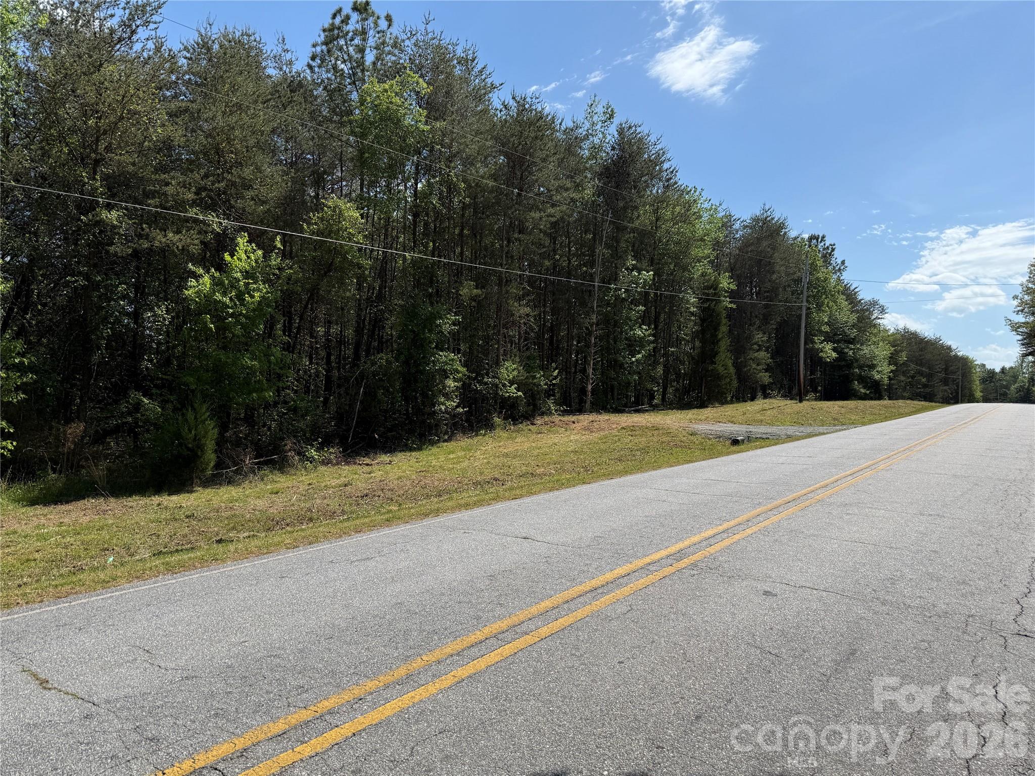 Fantastic acreage with stream located on Hugh Champion Road! Approximately 13.5 acres. Gorgeous little creek meanders along the SE property line. Approx. 950' road frontage along state-maintained Hugh Champion Road. ~1.2 miles to Hwy 74 & only 7 minutes to Tryon International Equestrian Center! Multiple building lots! Could be subdivided. Survey is being worked on now. Very light restrictions: residential or farming use only, and no temporary structures. Otherwise, the sky's the limit! Feel free to walk the property! Look for the new temporary pull-off near the center of the property on Hugh Champion Rd. Walk into the woods from the pull-off and we have marked with green & pink ribbons a trail down to the beautiful stream. Walk along the stream to the far corner. Landglide or similar app is very helpful. Or, call us to walk the property with you!