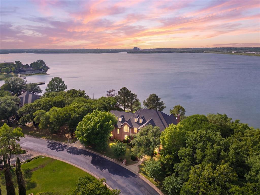 Luxury lake living at its finest—where every day feels like a getaway. Welcome to your private lakefront retreat in the exclusive gated community on Lake Arlington. This beautifully updated home has been thoughtfully redesigned with high-end finishes and extensive upgrades throughout, including new flooring, fresh interior paint, new cabinetry, a stunning island with marble countertops, brand-new appliances, all new air ducts, and two new HVAC systems.Panoramic windows span the entire back of the home, showcasing breathtaking water views while filling the space with natural light.Designed for both everyday living and effortless entertaining, the property features a sparkling pool and expansive outdoor living areas perfect for hosting or relaxing in a serene setting. Situated on a large, private lot, this home offers exceptional privacy and a true escape from the everyday.Residents enjoy exclusive access to a private community dock and clubhouse, adding convenience and enhancing the lake lifestyle. This rare, move-in-ready home combines luxury, comfort, and unbeatable views—an exceptional opportunity on Lake Arlington.