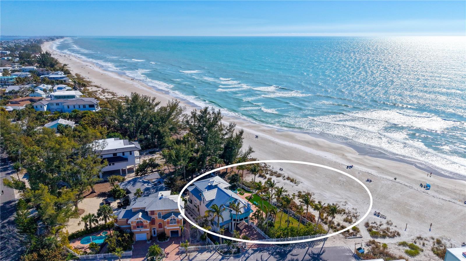 Views abound in this exquisite beachfront retreat in the heart of Anna Maria Island. This 3-bedroom, 3.5-bath Coastal West Indies–inspired residence showcases exceptional craftsmanship, including custom millwork, solid oak flooring, vaulted ceilings, designer draperies, and Roman shades throughout. An open-concept floor plan fills the home with natural light, while expansive windows and glass doors frame picturesque Gulf views and create seamless indoor-outdoor living—ideal for entertaining. The gourmet kitchen is beautifully appointed with solid wood cabinetry, a paneled refrigerator, custom solid-surface countertops, and a Thermador range. The primary suite is a private sanctuary where you’ll awaken to sweeping views of the turquoise waters of the Gulf. The spa-inspired bath features dual vanities and a luxurious walk-in shower with a striking stone waterfall accent. Hand-carved custom wood doors enhance the suite’s privacy, while a private sitting area just outside provides an additional space to unwind. The third level offers two well-appointed guest suites, each with breathtaking views and elegantly finished en-suite baths.On the lower level, a welcoming foyer with a custom staircase and private elevator provides access to all floors. The oversized two-car garage includes built-in storage cabinetry, and a versatile bonus area offers additional space for entertaining or recreation. Set on a lush half-acre lot with mature landscaping and thoughtfully designed outdoor lighting, the property highlights a stunning beachside pool and spa, covered lanai, private outdoor shower, and roll-down hurricane shutters. Multiple decks provide the perfect vantage point for sunset views and tranquil beach watching.Schedule your private showing today and experience the ultimate in beachfront living.