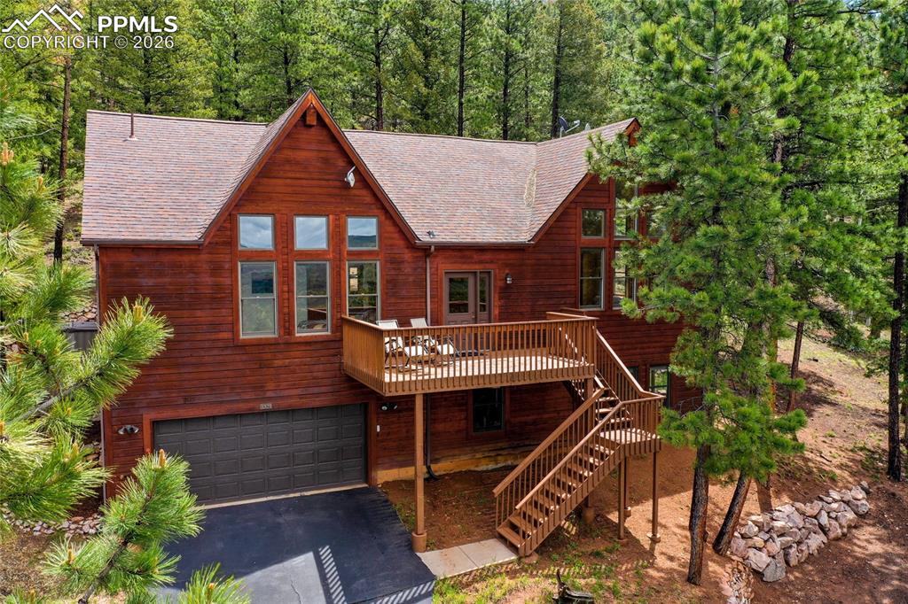 Welcome to “Forest’s Edge” — Where the Climb is Worth the View.  Set high above the ordinary on 2.23 acres and backing directly to National Forest, this 3-bed, 3-bath mountain retreat offers privacy, presence, and a front-row seat to Colorado’s ever-changing beauty.As you make your way up the private, tree-lined drive, something subtle happens—the noise fades, the air feels a little crisper, and the views begin to open up. And then you arrive… to a newly expanded turnaround that makes coming and going easy, and a setting that simply wouldn’t be possible from below.Because up here, you don’t just live in the mountains—you see them.Homes tucked low can offer convenience… but they can’t offer this.Step inside and you’re welcomed by warm wood tones, an expansive living room anchored by a cozy stone-accented fireplace, and skylights that frame the forest like living artwork. Light filters through the aspens, dancing across the hardwood-look tile floors and creating a space that feels both grounded and alive.The heart of the home is a beautifully remodeled kitchen—designed for connection. Whether it’s slow mornings, shared meals, or a glass of wine that turns into a long conversation, this is where life happens.Out back, the experience continues. A private deck and hot tub invite you to soak under a canopy of stars, with nothing but the sounds of nature and the occasional visit from deer or elk. With National Forest as your backyard, your sense of space doesn’t stop at the property line—it expands.Inside, three spacious bedrooms, a thoughtfully updated layout, and a 2-car garage provide comfort and function, while outside, the land itself invites exploration, privacy, and room to breathe.This isn’t for everyone—and that’s exactly the point.For the buyer who understands that elevation brings perspective, that privacy is priceless, and that the best views are never at the bottom…Welcome home to Forest’s Edge.