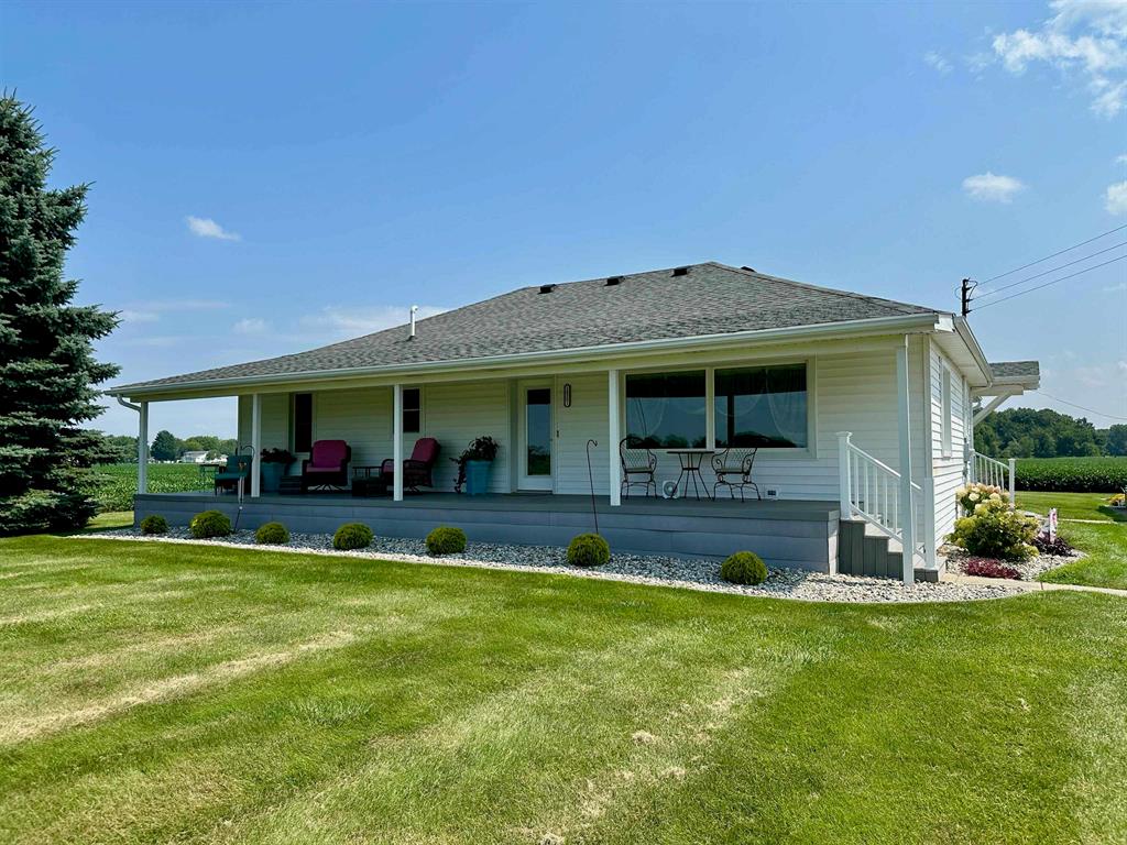 Welcome to your dream country retreat! This beautifully maintained 3-bedroom, 2.5-bathroom ranch home offers over 1,750 square feet of comfortable living space, all nestled on 77.2 sprawling acres of prime farmland, approximately 10 acres of which is wooded. Perfect for finding that trophy buck!  From the moment you arrive, you'll be captivated by the charm of the 47-foot covered country porch-the perfect spot for morning coffee or evening sunsets. Step inside to find thoughtful updates throughout, including a recently added first-floor laundry and half bath, a new roof in 2019 and an incredible rear family room addition with breathtaking panoramic views and gorgeous natural light which will beam off of the hardwood floors. This spacious room is the heart of the home, perfect for hosting those family gatherings and providing comfort year-round with a high-efficiency mini split for supplemental heating and cooling.  The master bedroom is your private escape, complete with a walkout to a covered patio where you can relax and soak in the peaceful beauty of your farmland backdrop.  Downstairs, the partially finished basement features a kitchenette, cozy living area, full bathroom, and additional laundry space-ideal for guests, entertaining, or multi-generational living. A battery backup for the sump pump adds peace of mind.  Outdoors, the property continues to impress with a detached 2-car garage, complete with a 20' x 12' lean-to, perfect for storage or workshop needs. On the northern edge of the parcel, you'll find not one but two large pole barns-a 70' x 40' and a 56' x 32'-offering endless possibilities for storing equipment, your big toys, livestock, or hobby farming.
