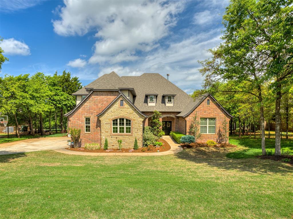 Luxury and tranquility await in the highly sought-after Bella Terra addition, where natural beauty inspires and convenience to Edmond and I-35 is unmatched. Located in the award-winning Edmond School District, this remarkable home sits on a 1.09-acre wooded lot and offers 3,264 sq ft of refined living with exceptional amenities throughout. Expansive windows frame breathtaking views of the pristine wooded setting, while the great room impresses with vaulted ceilings and a striking stone wood-burning fireplace. The chef’s kitchen features quartz countertops, a herringbone backsplash, and designer lighting, flowing seamlessly into a covered outdoor living area overlooking your private pond—perfect for relaxing or entertaining. The primary suite is a true retreat with a sitting area, private patio access, a spacious walk-in closet, dual vanities, soaking tub, walk-in shower, and convenient laundry access. Upstairs, two additional bedrooms share a Jack-and-Jill bath, accompanied by a bonus room complete with Bose speakers and a movie projector. Step outside to your backyard oasis, where a serene pond, peaceful wooded surroundings, and covered back porch create the perfect setting for quiet evenings or gatherings. Thoughtful upgrades make future enhancements effortless, including an outdoor firepit, gas stub-out on the back porch, and electrical already run to the pond—making it easy to expand your outdoor living into the paradise of your dreams. A full sprinkler system and meticulous care help keep the property looking its best year-round. Bella Terra offers exceptional neighborhood amenities, including a clubhouse, pool, playground, basketball court, soccer fields, and scenic rolling hills—all just minutes from I-35. With extensive interior and exterior upgrades and move-in-ready condition, this home is a rare opportunity. Schedule your private tour today and experience the beauty, comfort, and lifestyle this exceptional property has to offer.