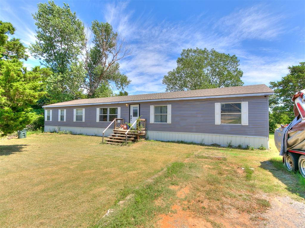 Nearly 2 ACRES that's close to I-35 & Waterloo Rd. Double wide mobile home with 4 bedrooms, 2 full bathrooms, 2 living areas, set in a quiet neighborhood that resembles a lake community with mature trees, people riding around on golf carts, peaceful, and serene.  Close enough to the city, but far away enough from the hustle & bustle of city life and traffic! This home has already had some updates completed.  A BRAND NEW HEAT PUMP SYSTEM WITH ALL NEW DUCT WORK! Pained cabinets in the kitchen along with a NEW DISHWASHER and KITCHEN SINK. The seller also upgraded the backsplash and changed the countertops. The island works wonderful as an additional prep space too. NEW HOT WATER HEATER! Primary bath has a shower, garden tub, and 2 vanities. See the sunrise over your wooded lot whilst drinking your morning cup of coffee on your NEW BACK DECK (partially covered) or enjoy plenty of space for entertaining and grilling in the evenings in the shade.  If you need storage out back, you're in luck as this property has a BRAND NEW 8X16 SHED for all your equipment and tools. This home will not go FHA or VA and seller prefers to sell AS-IS.