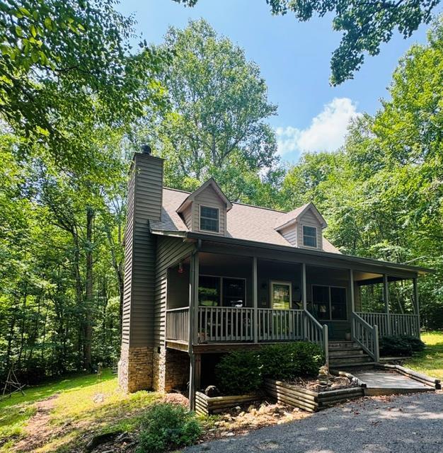 Your Mountain Retreat Awaits! Escape to the cool mountain air and discover the perfect getaway in the heart of Fancy Gap, Virginia. This beautifully maintained 2-bedroom, 2-bath log cabin with updated kitchen with a spacious loft offers the ideal combination of comfort, privacy, and resort-style amenities—making it a wonderful second home, vacation retreat, or full-time residence. Nestled on a private, wooded 3  lot in a sought-after gated community, this inviting home welcomes you with a large covered front porch where you can relax with your morning coffee and enjoy the refreshing mountain breezes. The screened-in back porch provides the perfect place to unwind while listening to the sounds of nature and taking in the peaceful surroundings. Inside, you'll find a warm and inviting floor plan featuring two comfortable bedrooms, two full baths, and a generous loft that can easily serve as additional sleeping space, a home office, or game room for family and guests. Beyond your front door, you'll enjoy an exceptional lifestyle with community amenities that include a heated swimming pool, tennis courts, pickleball courts, a fishing pond, clubhouse, and pool house—offering something for everyone throughout the seasons. Located just 2.5 miles from the charming town of Fancy Gap and only moments from the Blue Ridge Parkway, you'll have easy access to scenic overlooks, hiking trails, wineries, local restaurants, and the many outdoor adventures that make the Blue Ridge Mountains one of Virginia's premier destinations. You are 15 minutes from Mt Airy NC. Whether you're looking for a weekend escape from the city, a place to create lasting family memories, or an investment opportunity , this charming cabin offers the privacy, location, and lifestyle you've been searching for. Come experience the beauty of mountain living, where cool summer breezes, peaceful wooded surroundings, and resort-style amenities create the perfect place to relax and recharge. Gated community !