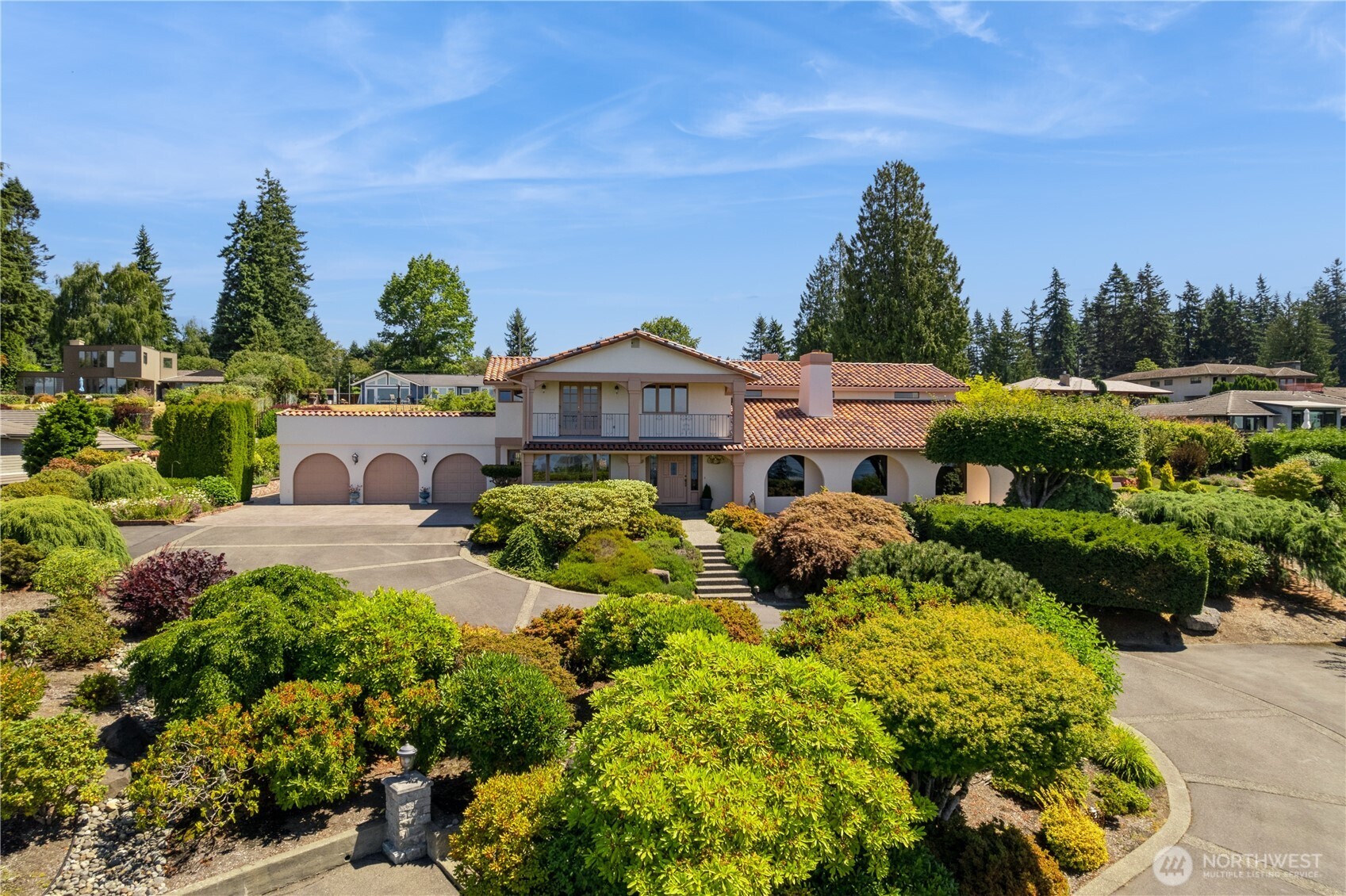 Innis Arden Mission Revival with sweeping sound/mountain views on 1.24 lush, meticulously-landscaped acres set privately at the end of a graceful, winding drive. The main floor includes a vaulted living room, formal dining, family room, office, & spacious chef's kitchen with casual dining area. Upstairs features a primary suite with panoramic view, elegant master bath & huge rooftop deck, plus three bedrooms overlooking the parklike grounds. Oversized 3-car garage has a separate workshop. Exclusive Innis Arden community amenities: pool, tennis courts, playfield & clubhouse. This immaculate home has been lovingly maintained by the original owner and includes countless tasteful & clever custom updates for you to discover, both inside & out!