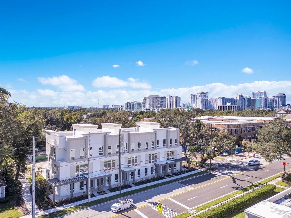 BRAND NEW! NOW AVAILABLE! 3 bed/3.5-bathroom residence featuring an open loft-style living and kitchen design. An exceptional entry level opportunity enhanced by upgraded light cabinetry. Units professionally designed by Carla Acosta Interiors. Vilasa Thornton Park combines luxury with location in the heart of Thornton Park.  Just blocks from Lake Eola and Downtown Orlando experience upscale living in this  townhome in the vibrant Thornton Park neighborhood, where you can walk to dining, coffee shops and shopping. Designed for both elegance and convenience, this home features a spacious open layout, and stunning city views. Upon entering, you’re welcomed by a large foyer leading to a versatile first-floor bedroom with a private bathroom- ideal as a private guest suite, home office, or in-law suite. This level also includes a two-car garage with a generous storage closet. The second floor is bathed in natural light, showcasing a gourmet kitchen with stunning, custom floor-to-ceiling cabinetry, high-end Stainless Steel appliances, quartz countertops, waterfall island and floor to ceiling windows. The spacious dining and living areas provide ample space for relaxation and entertainment, rich with character and warmth.  Upstairs you will find the primary suite boasting spacious closets and a luxurious bathroom with abundant storage and natural light. The secondary bedroom with its own private bathroom and a cozy open space-perfect for a reading nook, sitting area, or home office. Rooftop offers unparalleled views of Downtown Orlando. The 11-unit townhome community, plus a duplex, is perfectly positioned near Thornton Park’s charming restaurants, boutiques, and salons. Lake Eola’s vibrant events, Sunday Farmers Market, and yoga in the park are just steps away, offering a lifestyle rich in culture and recreation. Walk a short distance to Broadway shows at the Dr. Phillips Center, basketball at Kia Arena, and Michelin-starred restaurants in the Mills 50 District. With Orlando Health and AdventHealth, a couple of miles away, this home is the perfect match for medical professionals. Don’t miss your opportunity to own an elegant urban retreat in one of Orlando’s most sought-after neighborhoods. Vilasa Winter Park sold out in record time. Trusted and reputable builder, Jordan Homes.