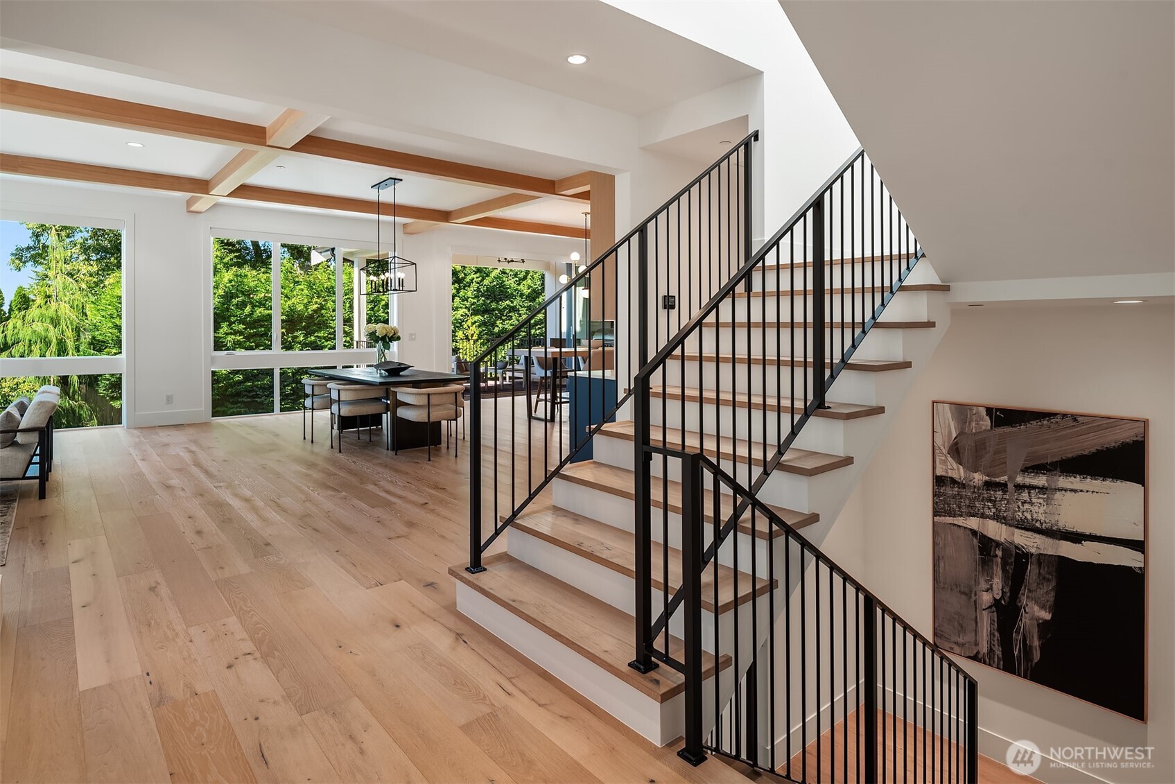 Open foyer with staircase and view to the dining area