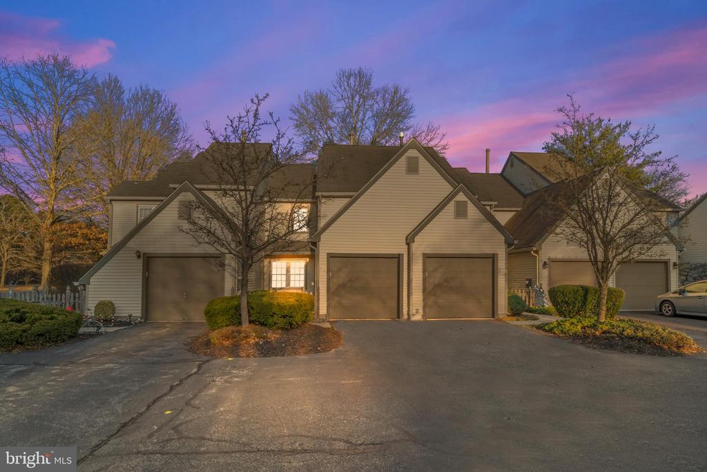 Welcome to 2 Woodlake Dr — a spacious 1,297 sq ft townhouse tucked away in the tranquil, lake-side community of Woodlake. Inside you’ll find rich hardwood floors, cathedral ceilings, and a beautifully updated galley-style kitchen featuring modern appliances, granite countertops, elegant cabinetry, and a stylish tile backsplash — perfect for everyday living. The living room offers a warm and inviting feel with a brick fireplace, vaulted ceiling, and skylights that fill the space with natural light. Upstairs includes two generous bedrooms and a full bath, while the main floor provides a convenient powder room and laundry. Step outside to your private balcony or patio to enjoy peaceful surroundings, and appreciate the ease of an attached garage with inside access plus driveway parking. Exterior maintenance, snow removal, landscaping, and exterior upkeep are all handled by the HOA — delivering a low-maintenance lifestyle. As part of the Woodlake community, residents have access to a clubhouse, outdoor pool, tennis courts, playground, and lake privileges — a setting ideal for those who value comfort and community amenities.