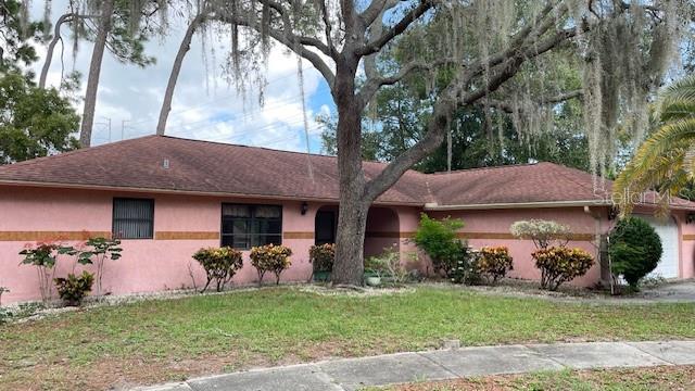 Whoa Nellie! You have to stop and check this out. Best deal in town for Tarpon Springs. Look at this solid built family home that has been well maintained by the same owner for 35 years. It must be something special for someone to love it for that long. Could it be the location, snuggled at the end of a cul-d-sac under live oak trees in Oakleaf Village. A sought-after neighborhood of well-kept homes and tree lined streets with it's own city park where children can play without having to worry about traffic. Speaking of traffic, there is none. Not on this street. When you drive up, you're gonna find a family home with a newer roof, central a/c, and water heater. See what I mean, the bones are all there. The big ticket items have all been replaced. A little cosmetics and you're off and runnin. Don't let it pass you by. This home is in the perfect location with a short jaunt to shopping, medical, beaches, and the world famous Sponge Docks. Don't take my word for it, "come on down" and see for yourself. You'll be glad you did..
