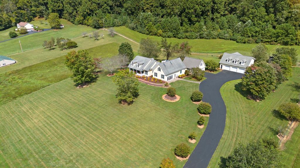 A rare opportunity to own a private riverfront retreat designed for peace, independence, and a more sustainable way of living. Enjoy the beauty and tranquility of riverfront living with views of the North Fork of the Holston River and the Clinch Mountain, where quiet mornings and abundant wildlife create a setting far removed from the conflicts and busyness of today's world. The main home features one level living with 3 bedrooms and 2.5 bathrooms, and inviting living spaces that include a living room, den, dedicated home office, and laundry room. Two gas fireplaces provide warmth and atmosphere, while heat pumps ensure efficient year-round comfort. Designed with independence and reliability in mind, the home includes a full-house standby Generac generator. An outdoor wood boiler is an alternative heat source supplying both space heat and hot water to the main house and guest house. The property also benefits from well water, offering an additional level of self-sufficiency. High-speed internet through Starlink allows you to stay connected while enjoying the peace of rural living. A separate guest house provides ideal accommodations for visitors, extended family, or potential rental income. To date, the guest house has hosted over 200 visitors. The property also includes garage space for up to 5 vehicles, perfect for recreational equipment, or workshop space. Gated driveway entrance with electronic keypad access. There is ample space for gardening, fishing, kayaking, and enjoying nature, this unique property offers a rare opportunity to create a peaceful lifestyle surrounded by natural beauty. Crawlspace was encapsulated in 2023 by Master Services. Main house is 2925 total finished sq ft and the guest apartment above the garage is 877 total finished sq ft. Call today for your private showing.