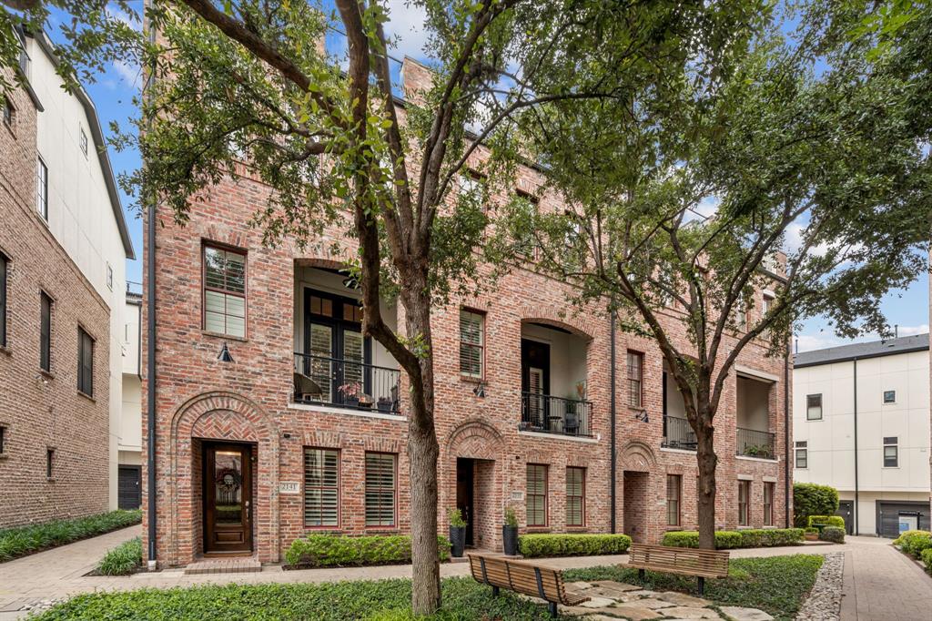 Experience elevated urban living in this stunning 4 story luxury townhome directly across from the Dallas Farmers Market, featuring designer upgrades & a fully enhanced rooftop terrace with skyline views. Ideally situated as an interior end unit, this home benefits from additional windows & abundant natural light, along with close proximity to the community pool—offering both privacy & convenience within the neighborhood.Thoughtfully designed w 3 bedrooms & a highly functional floorplan, the home blends flexibility, comfort & modern sophistication. A first-floor bedroom w ensuite bath & double doors provides the perfect space for guests, a private office or fitness room. The main living level is built for entertaining, showcasing an open-concept layout with continuous wood flooring throughout the home, plantation shutters, designer lighting, and seamless indoor-outdoor flow to a private balcony. The chef’s kitchen features premium quartzite countertops, a large island, gas cooktop, white cabinetry and abundant storage, delivering both elevated design and durability. Upstairs, the spacious primary suite serves as a true retreat, complete with a stone fireplace and spa-inspired bath featuring a soaking tub, separate shower, dual vanities & an oversized walk-in closet. An additional bedroom & conveniently located laundry complete the level. The defining feature of the home is the rooftop terrace, designed for year-round use with turf flooring, a custom awning, integrated misting system & gas connection for a fireplace or outdoor kitchen—all set against sweeping Downtown Dallas skyline views. This space functions as a true extension of the home’s living and entertaining area. Located in a beautifully maintained community with pool & walkable access to the Farmers Market, dining, coffee & entertainment, this home offers a rare combination of enhanced natural light, consistent high-end finishes, functional outdoor living & superior positioning within the community.