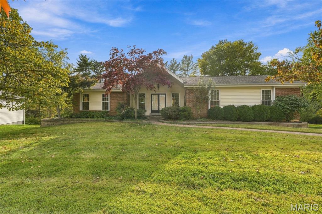 Light-filled four bedroom ranch in desirable Highcroft Estates brings together a peaceful natural setting and convenient proximity to fine shopping. Double front doors lead to an expansive living room and open sunroom with vaulted ceilings and beautiful views of the wooded area in back. Ideal for entertaining, the living room is centered by a large wood-burning fireplace; the dramatic sunroom – glass on three sides - has elegant, heated travertine floors and a door to the newly painted deck. There is a stylish separate dining room and a large eat-in kitchen featuring warm honey oak cabinets with lots of storage drawers and cupboards, a new floor, newer stainless steel appliances and a new gas cooktop. Sliding glass doors open from the kitchen onto a cedar deck and more wooded views.  There are three bedrooms, two full baths and a powder room on the main level. Master suite with bath has a generous walk-in closet.Down the newly carpeted stairs to the spacious lower level is a cozy family room with gas fireplace, newer luxury vinyl plank floors and sliding glass doors to a brick patio. A fourth bedroom with full bath could be used as an office or guest suite. The ample laundry room includes gas washer and dryer, a newly added 50-gallon water heater and a large walk-in cedar closet.  The oversized two-car garage features built-in shelving, a worktable and extensive storage. Roof and the heating/cooling unit are seven years old. This house has been well-maintained, thoughtfully landscaped and freshly painted throughout. Behind the property is a creek and common ground maintained by the HOA. Howehill shines as an appealing family neighborhood with fine schools, natural beauty, and access to enjoyable parks and a community swimming pool.