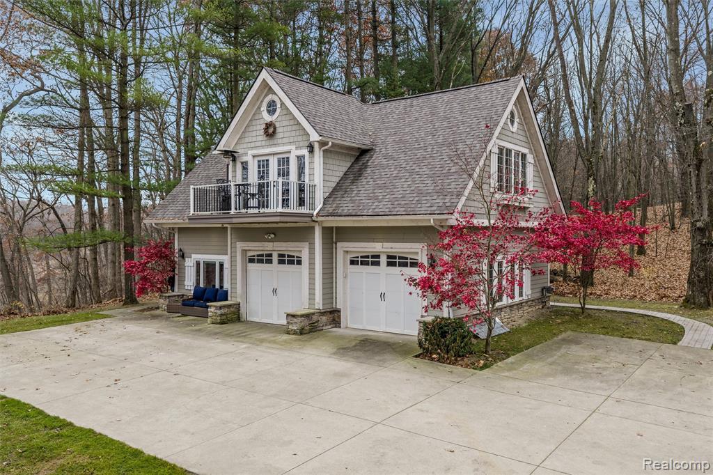 This stunning 24 acre property is waiting for its next owner to enjoy the peace, privacy, and endless recreation that Buckhorn Lake offers. Set on a private, all sports lake, this rare opportunity gives you the perfect blend of hunting, fishing, boating, and pure Up North tranquility without ever leaving home. The charming cottage is ready to enjoy as a private retreat or use it while you plan and build your dream home. Upstairs, the main living space offers an open, updated feel with a beautiful gourmet kitchen complete with stainless steel appliances including a gas stove, built in microwave, dishwasher, and refrigerator, a large center island, generous cabinetry, granite countertops, and an under mount sink. Wood plank flooring runs throughout the kitchen, dining room, great room, and bedroom for a warm, cohesive look. French doors off the dining room open to a balcony overlooking the lake which is the perfect spot for morning coffee or evening sunsets. The great room features a cozy corner gas fireplace, and the full bath includes travertine tile and a granite top vanity. The lower level offers a spacious second bedroom with baseboard heat, attached garage with full pull down screen doors, perfect for entertaining and plenty of storage for all out your outside toys. Beach house/ shed with loft and plumbed for a full bath.  Don't miss this incredible opportunity!