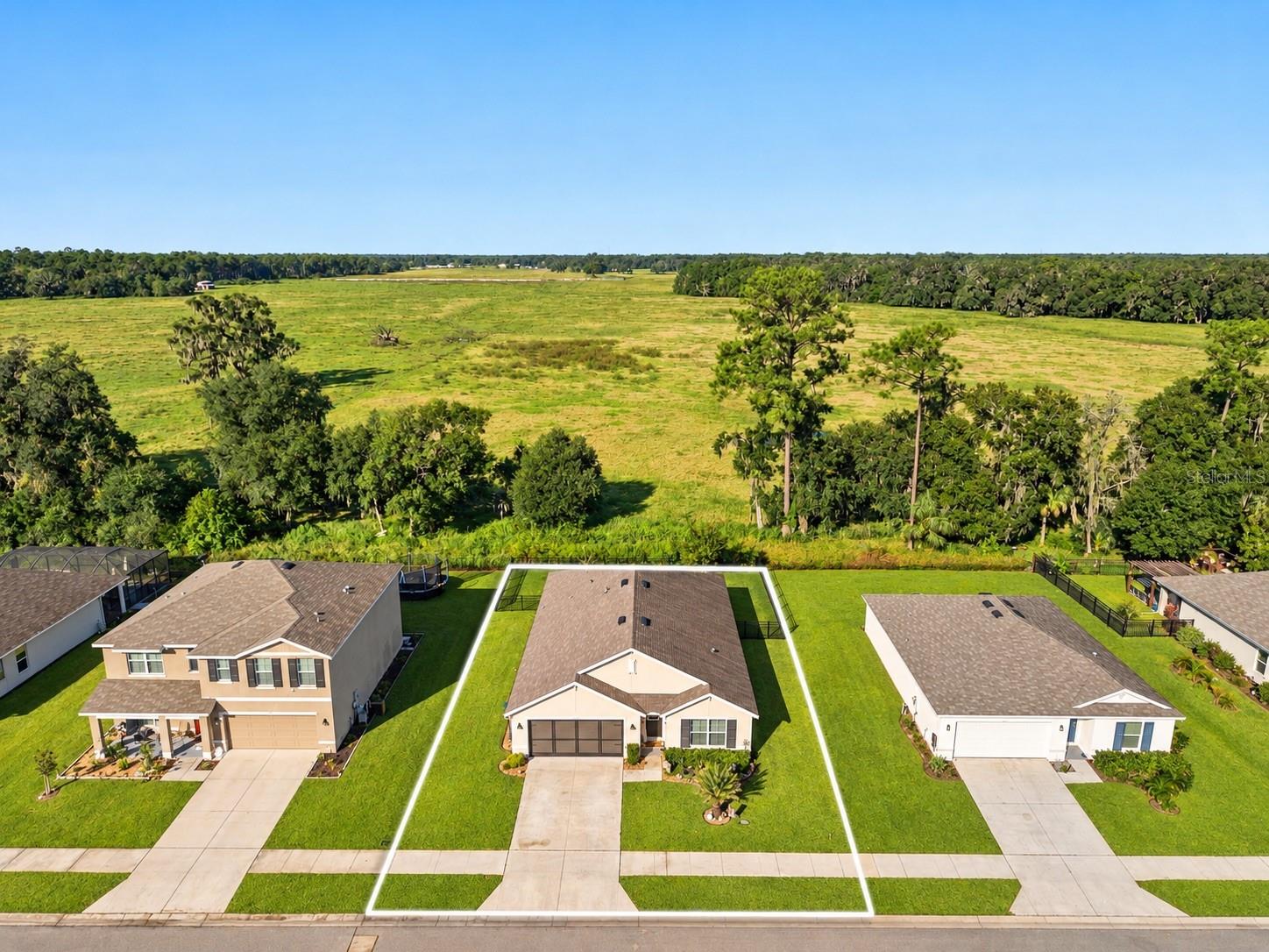 NO MONEY DOWN + NO REAR NEIGHBORS + GATED GOLF COURSE COMMUNITY + 4 BEDROOMS! What if you could buy a MOVE-IN READY home with NO MONEY DOWN? Located in a USDA ELIGIBLE AREA, this 2021-built home offers the opportunity for qualified buyers to take advantage of USDA financing while getting 4 BEDROOMS, 2 FULL BATHROOMS, a 2-CAR GARAGE and 1,830 SQ FT of living space in the gated community of HERNANDO OAKS! But the location within the community may be one of the best parts. Tucked away on a QUIET DEAD-END CIRCLE, the home backs to ACRES OF OPEN LAND with NO REAR NEIGHBORS, giving the backyard a peaceful, private feel that is hard to replicate. The FULLY FENCED BACKYARD offers plenty of room to enjoy the outdoors, while the SCREENED REAR PATIO creates a shaded spot to sit back, unwind and take in that VIEW.Inside, the OPEN-CONCEPT layout feels spacious and functional, with a SPLIT-BEDROOM FLOOR PLAN that gives the primary suite separation from the additional bedrooms. Four bedrooms give you options for guests, a HOME OFFICE, hobby space or whatever fits your lifestyle. And with the home built in 2021, you get the appeal of newer construction without waiting for a home to be built! More features include a WHOLE-HOUSE WATER SOFTENER + SPRINKLER SYSTEM + SCREENED GARAGE DOORS + SMART HOME FEATURES. >>> Want the COUNTRY CLUB LIFESTYLE without giving up everyday convenience? HERNANDO OAKS is a GATED GOLF COURSE COMMUNITY offering a golf course, driving range, pro shop, clubhouse restaurant and PICKLEBALL, along with community activities and events. And with convenient access to US-41 and the SUNCOAST PARKWAY, getting around Hernando County or heading south toward Tampa is easy. 4 BEDROOMS + 1,830 SQ FT + BUILT IN 2021 + FENCED BACKYARD + NO REAR NEIGHBORS + SCREENED LANAI + GATED GOLF COMMUNITY + NO CDD + LOW HOA! Come see why this tucked-away spot in Hernando Oaks feels just a little different.