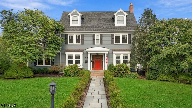 Center-hall colonial near downtown Westfield, renovated in 2025-26: all hardwood floors and stairs replaced with new wide-plank hardwood; new radon mitigation, water filtration and security systems; walls restored and repainted throughout. The work builds on a 2016 renovation with a three-story addition, a 2017 roof, fiber cement siding, Andersen windows and updated electrical, so the house is move-in ready. First floor: foyer; 23-foot living room with wood-burning fireplace, built-ins and box-beam ceiling; formal dining room; kitchen with large center island, stainless appliances including a built-in refrigerator, dry bar with wine refrigerator, pantry and banquette dining area; family room with gas fireplace; mudroom; powder room. Custom moldings and wainscoting. Second floor: primary suite with walk-in closet and full bath, three more bedrooms, two full baths and a laundry room. Third floor: bedroom suite with full bath and walk-in closet. Finished lower level with media, game and exercise areas, powder room and storage. Three-zone central air and multi-zone heat (steam, hot water, heat pump). Outside: level 0.28-acre lot, fenced rear yard with drainage, bluestone patio, in-ground sprinklers, exterior lighting and a detached 2-car garage. 0.1 mile to Wilson School, with downtown shops, dining, parks and the NJ Transit station close by.