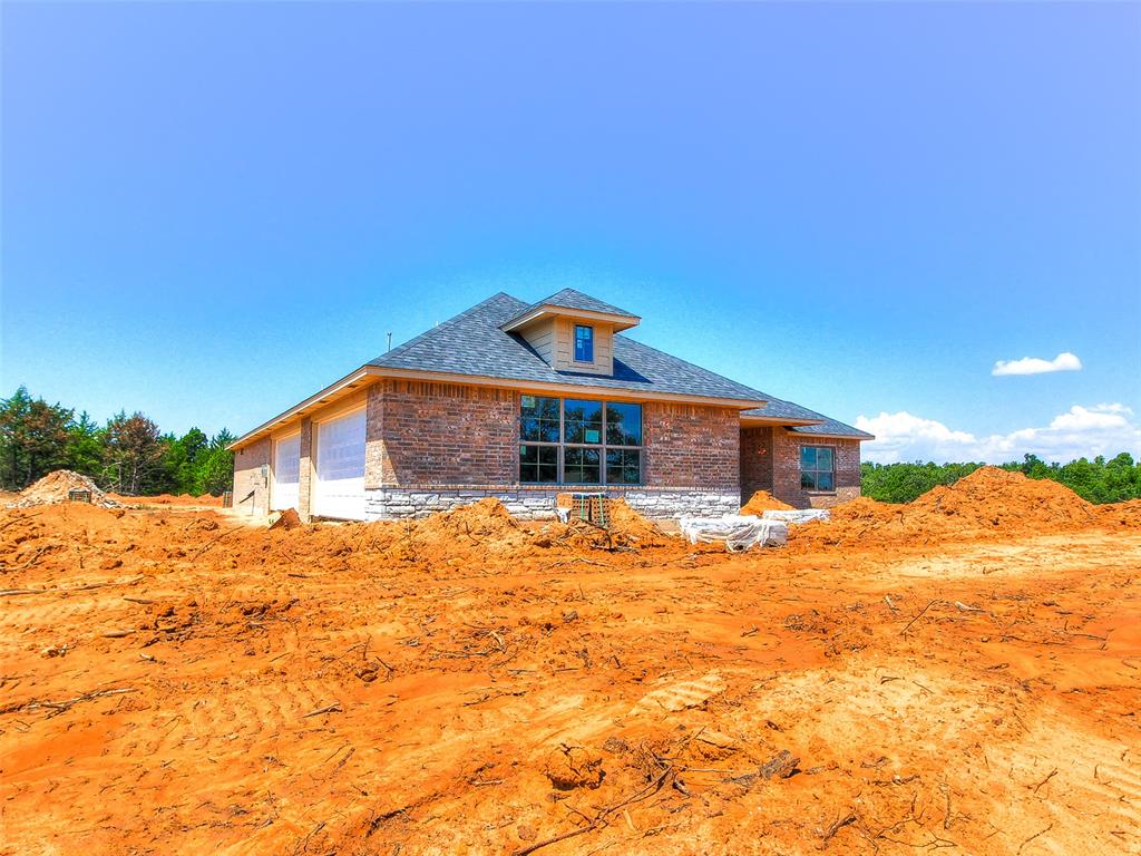 Welcome to your dream home in one of Edmond’s newest premier additions! This stunning new construction offers 4 spacious bedrooms, 3 full bathrooms, and a versatile media/rec room — all within 2,547 square feet of thoughtfully designed living space. Situated on a generous 0.75 acre MOL lot, this home blends modern comfort with room to breathe. As an added bonus, the seller is offering $5,000 in buyer incentives — use it toward closing costs, upgrades, or a rate buy-down to make this dream home even more affordable! The oversized 4-car garage features two 16' x 7' overhead doors, ideal for vehicles, tools, or hobbies. Enjoy both a covered front porch and a covered back patio — perfect spots to unwind or entertain guests. Step inside to find a warm and inviting family room centered around a beautiful wood-burning fireplace, perfect for cozy evenings at home. The kitchen features granite countertops, stainless steel appliances including a space-saver microwave, sound-insulated dishwasher, and disposal, plus plenty of workspace for everyday living or hosting. Additional perks include a private well and an aerobic septic system for added efficiency and peace of mind. This home has it all — space, style, and the serenity of country-style living just minutes from Edmond conveniences! Don’t miss your chance to own a brand-new home on a generous lot in one of Edmond’s most exciting new communities!