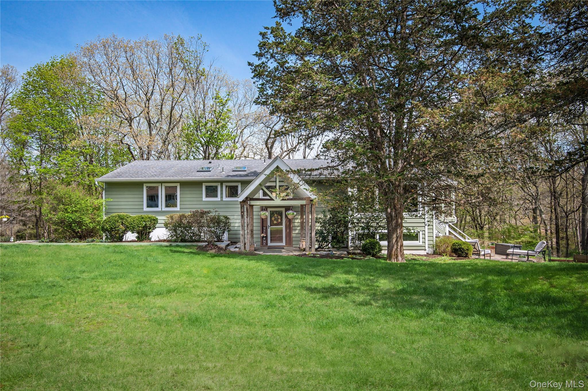 Nestled on a picturesque 1.25-acre setting in sought-after Pound Ridge, this updated Ranch-style residence offers thoughtfully renovated spaces throughout. Impeccably maintained, the home features 4 Bedrooms, 2.5 baths, and 2,576 square feet of comfortable, well-designed living space.A recently remodeled Chef's Kitchen serves as the heart of the home, blending style and functionality with modern finishes and an inviting layout with impressive Great Room -ideal for both everyday living and entertaining. Vaulted ceiling, exposed beams, a striking stone fireplace, and hardwood flooring throughout create a warm, cohesive atmosphere across the main living areas.The finished Lower Level is above grade and adds exceptional versatility, featuring an additional Bedroom, Office, Entertainment area, and dedicated Laundry Room. Seamless indoor-outdoor flow leads to an expansive deck and Screened-In Porch—perfect for dining, relaxing, and enjoying the peaceful, private surroundings. Additional highlights include a two-car attached garage, ample storage, generator and a serene, landscaped lot offering both space and tranquility.Enjoy the beautiful surroundings of Pound Ridge plus with convenient access to Metro North Train and commuting routes for Westchester and nearby Connecticut. Ideally located just minutes from downtown Ridgefield and popular Scotts Corners. This turn-key property combines comfort, style, and sought after location in one exceptional offering.