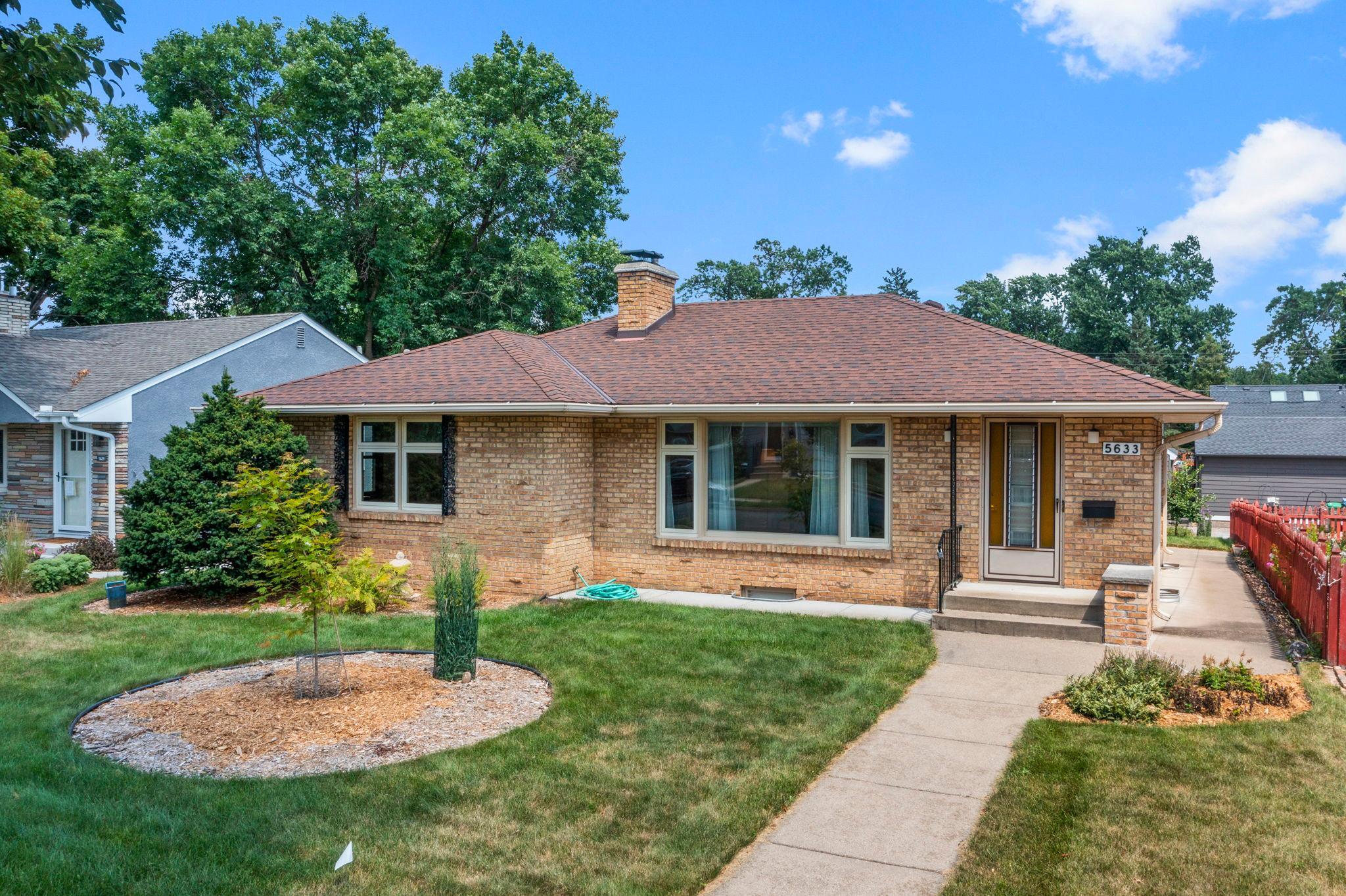 Full of timeless character, flexible living spaces, and room to truly spread out, this charming home offers the perfect blend of comfort and convenience. Ideally located near shopping, dining, major roadways, MSP Airport, Lake Harriet, and Minnehaha Creek, you'll enjoy easy access to everything Minneapolis has to offer.Inside, warm hardwood floors, oversized windows, classic brick wood burning fireplaces, and thoughtful built-ins create inviting spaces throughout.The main level features three bedrooms, a bright living room, dining room, an eat-in kitchen, and a cozy sunroom that seamlessly connects indoor and outdoor living.Downstairs, even more living space awaits with a spacious family room, recreation room, bonus room, finished laundry area, 1/2 bathroom, and abundant storage, offering endless possibilities for entertaining, hobbies, a home office, or everyday living.Outside, the large backyard, patio, detached two-car garage, oversized parking pad, and new double-hung windows installed throughout in 2023 complete this move-in-ready home!