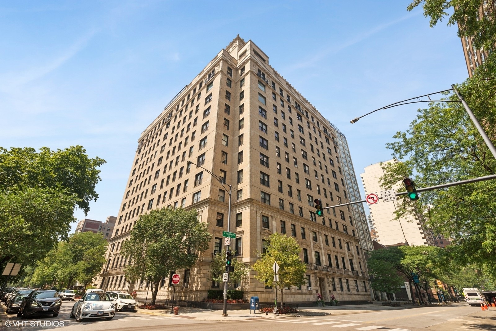 Welcome to The Barry, one of East Lakeview's prestigious pre-war high-rise buildings, designed and built by Robert S. De Golyer (architect) and Paschen Brothers (builder) in 1924-1925. Entering the building, you will be greeted by 24-hour door staff leading you to a gracious building lobby, which is beautifully furnished and appointed with a gas fireplace. The elevator will take you to the 11th floor and a semi-private, elegantly designed elevator lobby shared with just one neighbor. Apartment 11D centers around a gracious foyer, which leads you to all areas of the approximately 1800 square feet of living space. Immediately upon entering, you know you are about to see something very special. Whimsical, lovingly designed, and smart with modern features and old-world charm. The expansive living room is so welcoming with a gas-log fireplace and built-in features. The dining room is just back through the foyer and is the perfect space for entertaining and large enough for dual purposes. Adjacent to the dining room and leading to the kitchen is the well-appointed bar, ready for cocktails, wine, and coffee. The kitchen was recently renovated with custom dark-wood cabinetry, a Bosch appliance suite, and cool retro tile flooring. Beyond the kitchen is a well-organized "mud-room", office, laundry, bathroom, and pantry all in one! The bedroom hallway with original built-in storage leads to the guest bedroom, the large primary bedroom, and a large and bright bathroom. Many windows have been replaced or refurbished, high-velocity air conditioning and in-unit laundry are recent installations. The Barry offers additional storage, a main level courtyard for outdoor dining and grilling, playground/playroom, an exercise facility, and bike storage. Just one block from access to the parks and lakefront, restaurants, shops, and express buses just steps away, this is truly the perfect East Lakeview location.