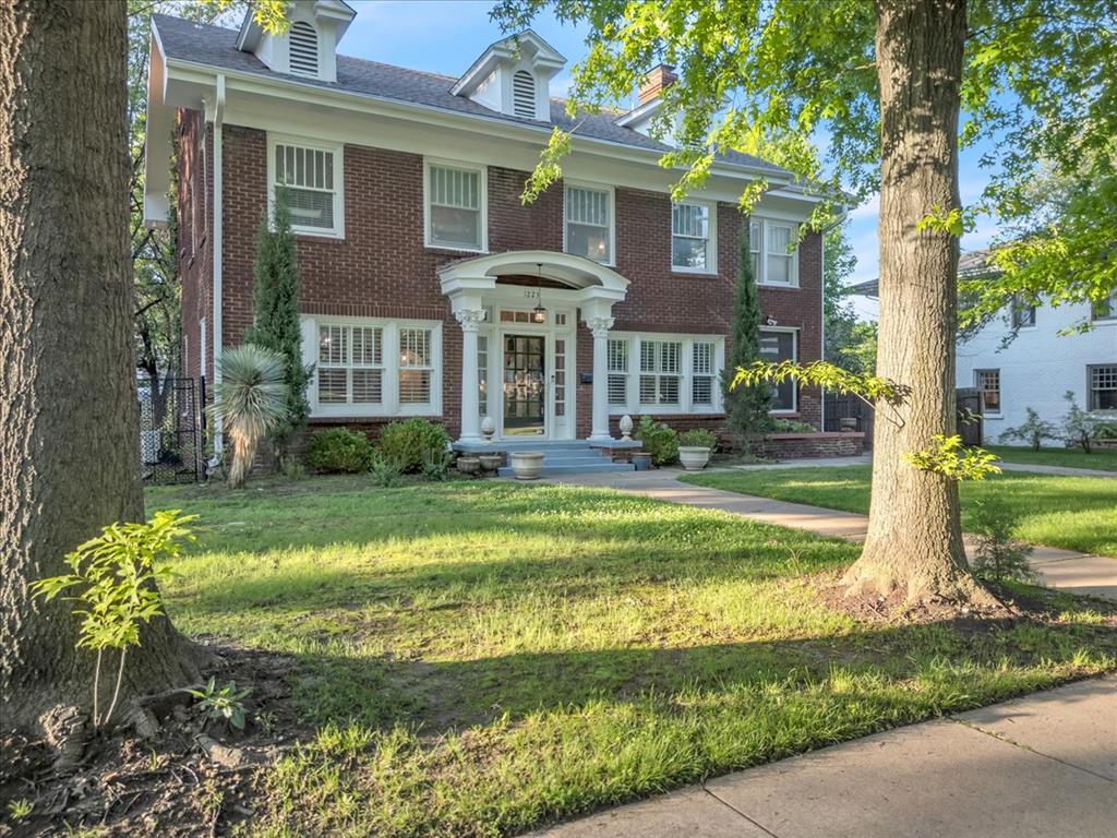 This historic estate blends timeless charm with modern elegance. From the moment you enter, original hardwood floors and streams of natural light set a warm, inviting tone, complemented by high-end finishes throughout. The grand foyer opens seamlessly into a sophisticated dining area and an expansive living room, where large original windows and a beautifully tiled fireplace take center stage. A bonus area off the main living space offers flexibility for a cozy lounge, playroom, or reading nook. The kitchen is a chef’s dream—expertly designed with Quartz countertops, shaker-style cabinetry, an eye-catching backsplash, and a generous breakfast peninsula with seating for three. Upstairs, four spacious bedrooms offer comfortable living for the whole family. The primary suite features a spa-inspired bathroom with dual marble vanities and sleek wall-mounted faucets, along with private balcony access—perfect for quiet mornings with coffee. Nestled on nearly half an acre, the lush backyard is an entertainer’s paradise with mature landscaping, a sprawling deck, and a large covered porch ideal for gatherings. All this, just minutes from the vibrant culture and dining of the Plaza District, Uptown 23rd, and Midtown.