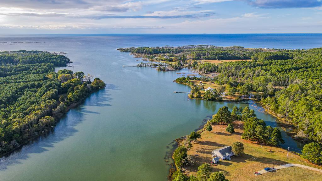 42.67 Acre Oasis. Completely private with 3 fields, approximately 2000 feet of waterfront and westerly views. Beautiful sunsets with direct line of sight to the Chesapeake Bay. Ideal for game and wildlife hunting, duck impoundments etc. No covenants or restrictions. House is modest; great for a second home but also makes an ideal full time residence with one level living. Open floor plan and like new. Recently updated primary suite bathroom with tiled, walk-in shower. LVP flooring throughout. Leathered granite counters in kitchen. New Deck 2024. Just a short drive to the town of Onancock.