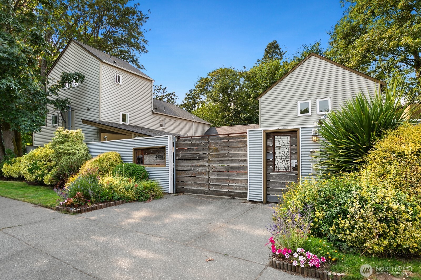 A truly unique three-level condo that lives like a townhome, overlooking Kiwanis Ravine with a peaceful treehouse feel. Fully updated and turnkey, the main level features a modern kitchen with new appliances throughout, a copper farmhouse sink and granite counters, plus an inviting living area that opens to a spacious deck. Exceptionally large bedrooms are thoughtfully located on separate levels, each with an ensuite bathroom and enough space for a king-size bed, work-from-home setup, fitness area or favorite hobbies. This flexible layout works beautifully for a variety of lifestyles. Enjoy secure covered parking just steps from your front door, with no stairs between them, plus a dedicated storage unit. An incredible location steps from Discovery Park, the Ballard Locks, Metropolitan Market and neighborhood amenities, with convenient access to downtown Seattle.