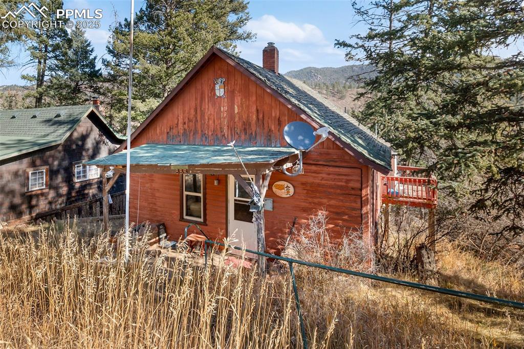 Charming mountain cabin in the heart of Green Mountain Falls! This 2-bedroom, 1-bath home offers classic Colorado character with wood-paneled walls, cozy living spaces, and plenty of natural light. The kitchen features rustic original cabinetry and large windows that capture peaceful views.  Nestled among mature trees and just minutes from downtown Green Mountain Falls, parks, and hiking trails, this home provides an ideal retreat or full-time residence. Ready for you to put your own finishing touches on the home!
