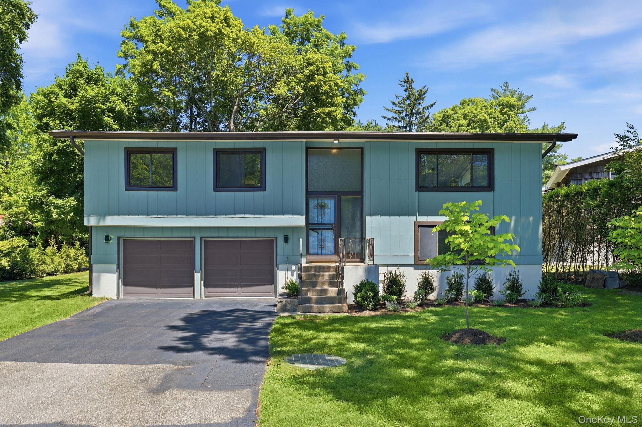 Beautifully renovated and reimagined, this sun-filled Contemporary Raised Ranch offers a seamless open floor plan designed for modern living. Dramatic vaulted ceilings, generous room sizes, and an abundance of natural light create an airy and inviting atmosphere throughout.The home features 4 bedrooms and 3 full baths, including flexible living spaces ideal for today’s lifestyle. The spacious kitchen flows effortlessly into the main living and dining areas, making it perfect for both everyday living and entertaining.Step outside to a large deck overlooking a private, professionally landscaped yard. Additional highlights include central air conditioning, a two-car garage, and a separate rear entrance providing excellent potential for a recreation room, guest suite, or work-from-home setup.This home offers a rare combination of thoughtful renovation, versatile space, and move-in ready condition. Short distance to Trader Joe's,  shops on Central Avenue, and transportation to the Metro North train. The Town of Greenburgh Pool and tennis courts are available.