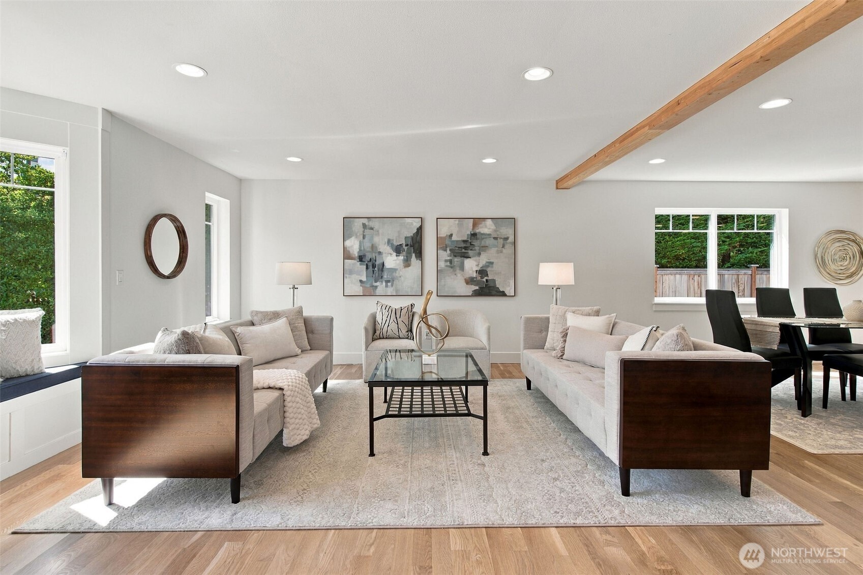 Hardwood floors, a wood-beamed ceiling and an open sightline to the dining room set the tone for easy, elegant living.