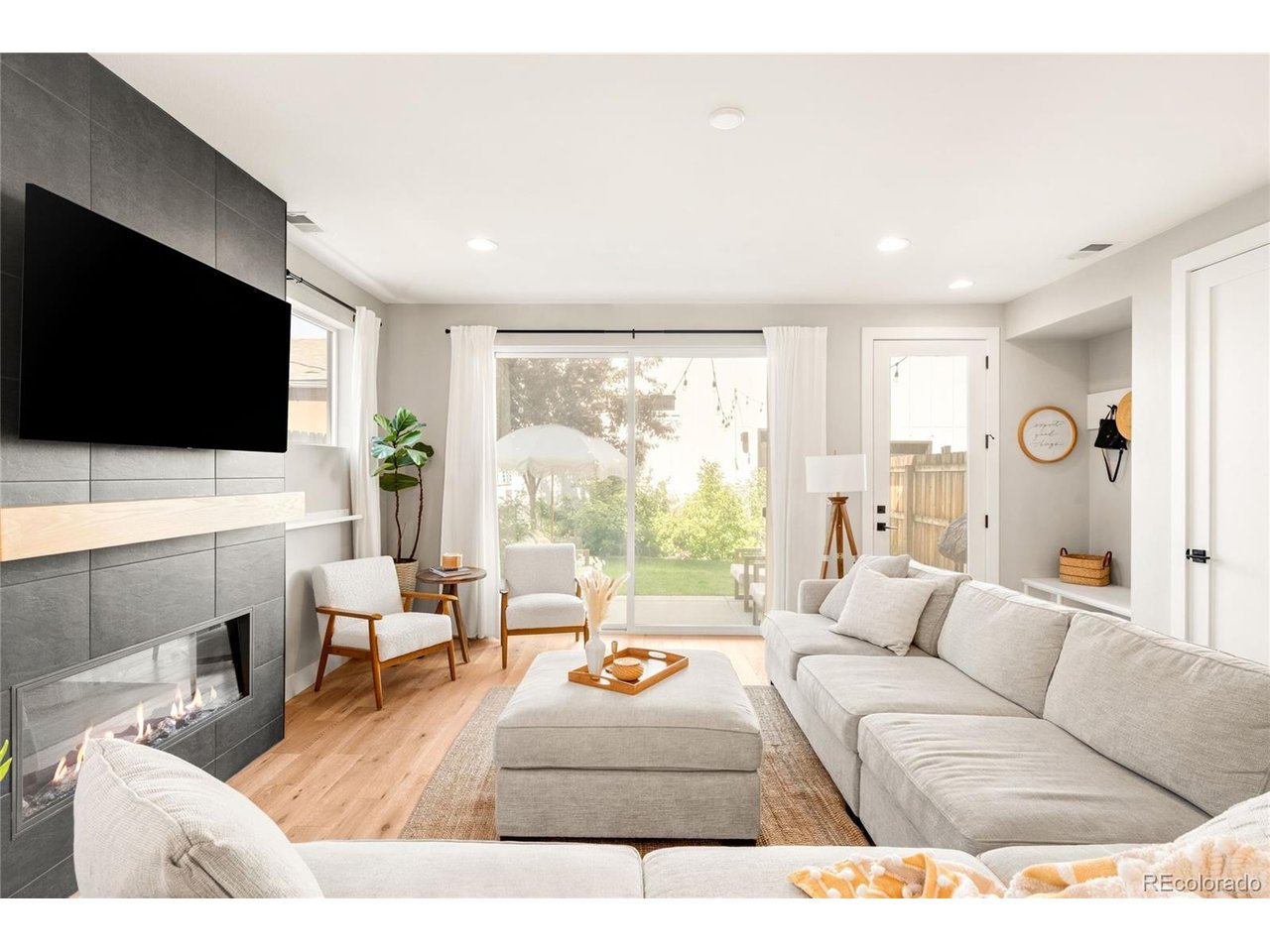 Built in 2022, this beautifully designed end-unit duplex offers the perfect balance of modern style, thoughtful functionality, and low-maintenance living. Bathed in natural light from its coveted south-facing orientation, the home features three spacious bedrooms, three bathrooms, a dedicated home office, and detached two-car garage.At the heart of the home, is an expansive open-concept kitchen, dining, and living area that creates an effortless space for both everyday living and entertaining. Large sliding glass doors extend the living space to a professionally landscaped backyard, offering a serene outdoor retreat with minimal upkeep-ideal for hosting friends or relaxing.The spacious primary suite is a true retreat, complete with a luxurious ensuite featuring a large walk-in shower, double vanity, private water closet, and generous walk-in closet. Two additional bedrooms are thoughtfully sized to comfortably accommodate queen beds, while a conveniently located second-level laundry room and full bathroom add everyday ease and flexibility.Perfectly positioned between Downtown Littleton and Downtown Englewood, with a quick commute to the Denver Tech Center, this home places dining, shopping, parks, and entertainment within reach. Combining contemporary design, abundant natural light, and an unbeatable central location, this move-in-ready home offers effortless living at its finest.