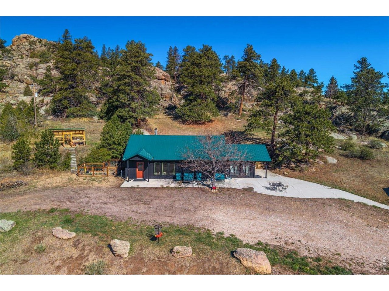 This is an incredible opportunity to own your very own mountain homestead, perfect for anyone looking to enjoy a peaceful rural lifestyle with their animals. Set in the scenic mountains of Northern Colorado in the sought after neighborhood- Green Mountain Meadows, 40 minutes from Fort Collins. This well-maintained property features a charming 3-bedroom, one-bath home situated on more than 16 acres with the National Forest right across the road. The house offers sweeping views of a spacious meadow and stunning mountain vistas, creating an idyllic backdrop for everyday living. Inside, you'll find refreshed kitchen with a Viking range and soapstone counter tops, new Pella windows, beautiful solid oak flooring, and outside you'll find fresh paint, a durable metal roof, and a large concrete patio ideal for outdoor entertaining. There's also a generous mudroom, plumbing already in place for adding a half bath, a dog pen, and a cozy wood stove to keep you warm on chilly nights-all tucked into a striking rock outcropping that adds unique character to the property. But that's just the beginning! The expansive 1,440-square-foot garage provides plenty of room for vehicles or equipment and includes a fantastic hangout area perfect for relaxing. A 36X13 hay barn, loafing shed with stalls, and a timber-frame greenhouse ready to be finished offer outstanding facilities for gardening and livestock. Domestic well rights allow you to water livestock and have a garden, a complete septic system with a leach field, this property is ready for comfortable year-round living. Whether you dream of starting a small farm, growing your own produce, or simply enjoying the tranquility of mountain life, this homestead delivers everything you need and more. Only a small road association, no overseeing hoa.