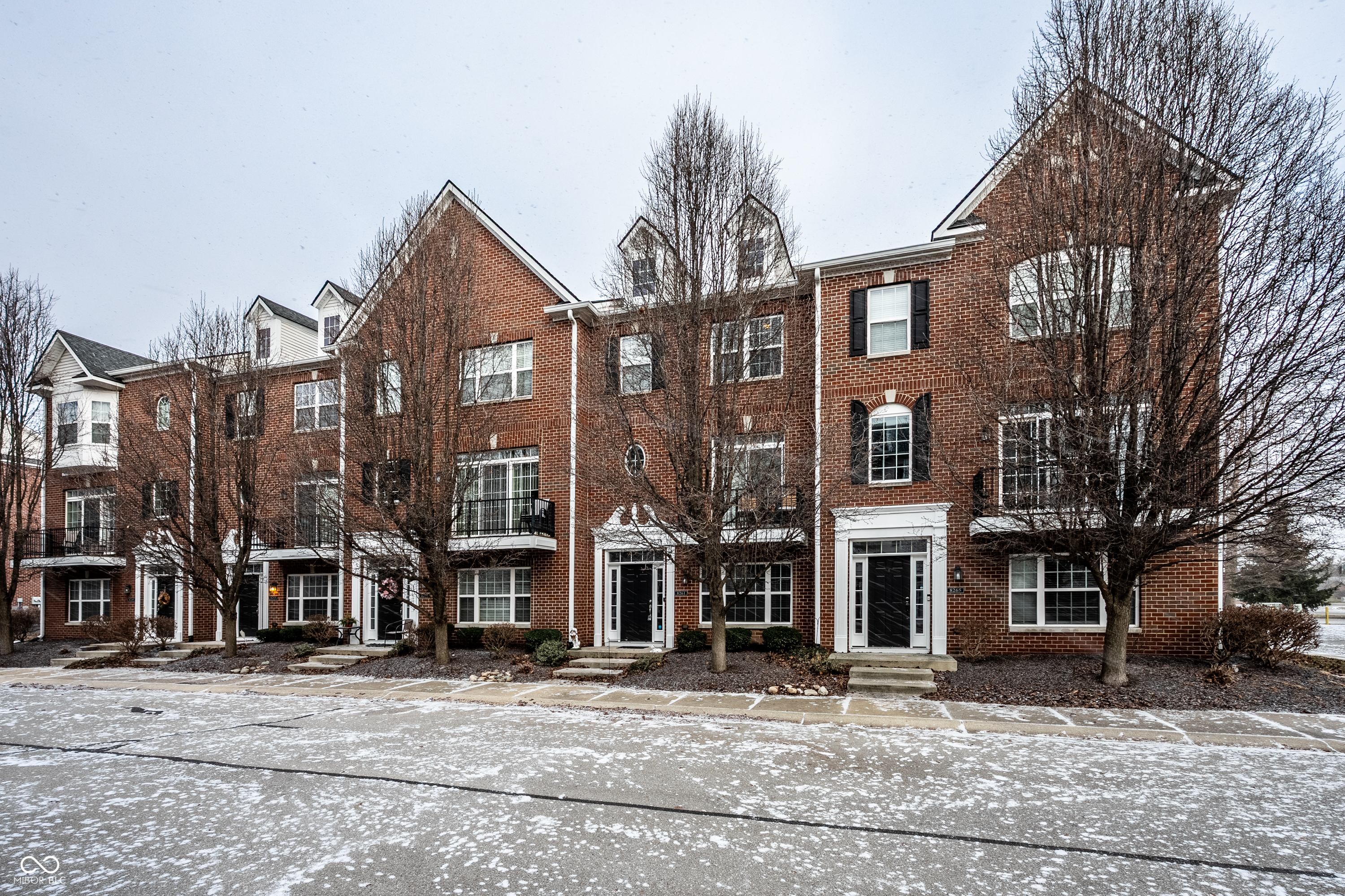 Welcome to this stunning 3-bedroom, 2.5-bath townhome perfectly positioned in the vibrant heart of downtown Fishers with incredible access to the Nickel Plate Trail. Enjoy the ultimate urban (ish) lifestyle with restaurants, shopping, and popular destinations like Wild Ginger, Chatham Tap, Mornings Breakfast and Brunch and The Yard at Fishers District just steps or a bike ride away. Located within quick access to I-69 for effortless commuting as well. Inside, you'll find a beautifully designed interior featuring gorgeous hardwood floors, raised ceilings and both formal and casual living spaces. The dramatic two-story foyer accented by elegant columns makes a striking first impression and leads to the lower-level den/office with French doors creating a perfect home office or flex space. The open concept kitchen showcases new appliances, solid surface countertops, a large center island, warm rich cabinetry, breakfast bar and large sliding door to one of the two balconies providing a cozy outdoor space for your morning coffee. The spacious great room serves as the heart of the home, complete with a cozy gas fireplace, beautiful trim detail and the second of two private balconies providing additional space and abundant light. Upstairs, retreat to the generously sized primary suite with vaulted ceiling, walk-in closet and double sink vanity. Two additional bedrooms provide comfort and privacy for family or guests. Recent updates also include new water heater. Additional highlights include a finished 2-car garage offering ample storage and parking. Whether you're seeking an active urban lifestyle or a low-maintenance, elegant home in a premier location, this downtown Fishers townhome truly has it all.