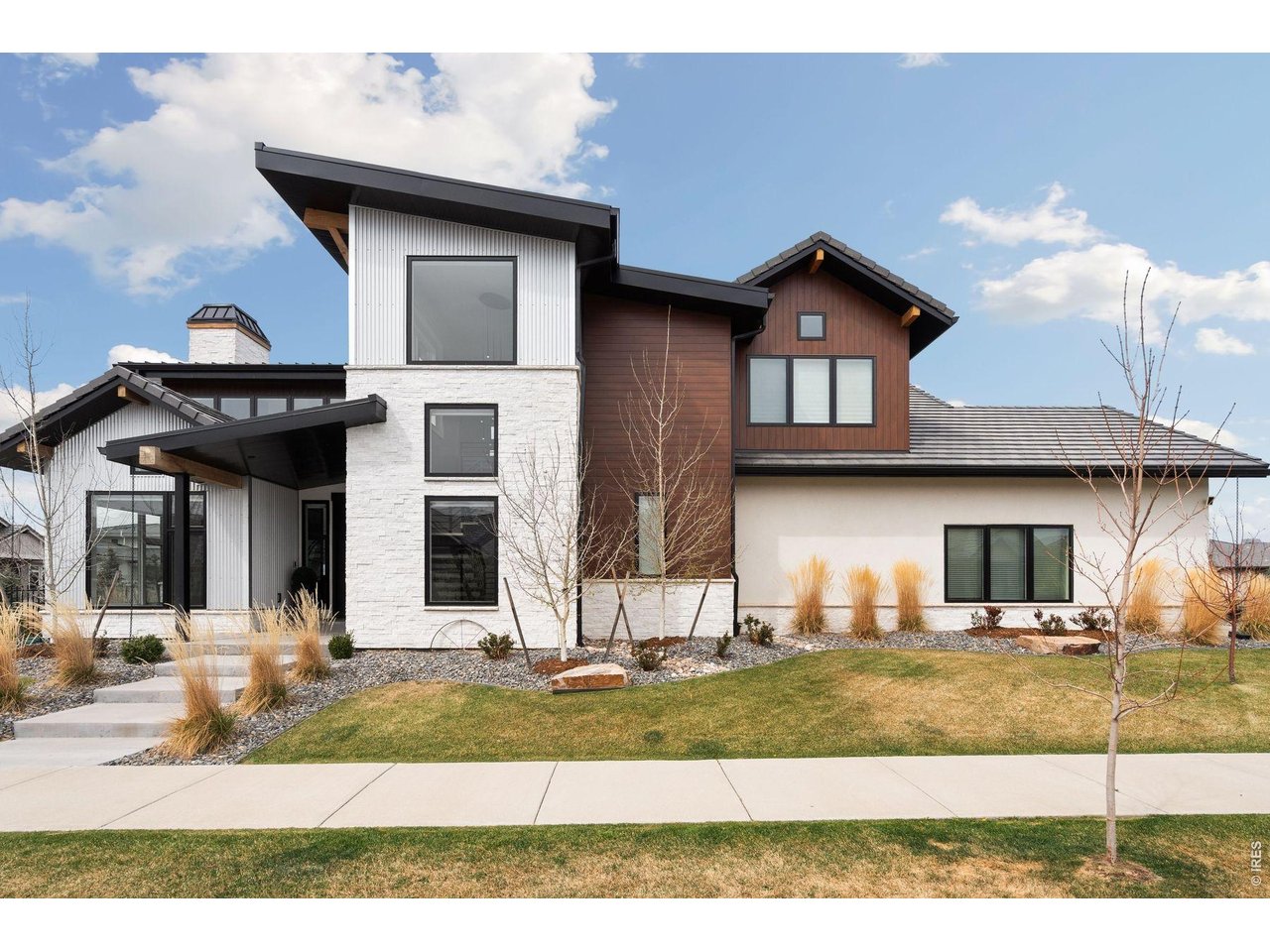 Custom 2 story, with 3 master suites each located on a different level. Breathtaking views of Lonetree Reservoir, Longs Peak and located in Heron Lakes at TPC Colorado. Priced below July 2026 Appraisal and 300k below replacement cost.This custom home has many upgrades throughout. Chefs' kitchen with dual islands, Thermador 6 burner stove with grill, steam oven and 6 burners. a stand-alone 2nd oven, built in refrigerator, built in dual climate wine fridge, dishwasher and microwave also all Thermador. Main level has a master suite with 2 closets, 0 entry shower, and heated floors. Great room with 21 ft floor to ceiling fireplace finished in hot rolled steel, 18-foot accordion doors that opens up to large patio, built in grill, 10-foot firewall, and views of Longs Peak and Lonetree Res. 2nd level has master suite 2, with fireplace, soaking tub, steam shower, heated flooring, and walk in closet with washer and dryer. Bedroom 4 with on suite and vaulted ceilings. Upstairs living room with outdoor deck also with views on Longs Peak and Lonetree. Basement has master suite 3 with tub and shower, large rec room, bar with Cristallo tops, wine room, dishwasher, fireplace, and off-season walk-in closet. 3 1/2 car heated garage, heated driveway, fenced in yard, and exterior has 0 maintenance finishes. Electric Hunter Douglas blinds throughout. All of this located in Heron lakes at TPC Colorado. As a resident you have access to the resort style pool, workout facility, Lonetree Reservoir allowing waterskiing, paddleboards, kayaks and canoes, Center Stage restaurant, The Cafe, and Waterfront Grill located on Lonetree Reservoir. With home purchase you may buy a discounted membership to TPC Colorado with an 18 hole Championship Golf Course that hosts a Korn Ferry event annually, high end practice facility including multiple chipping and putting greens, and 3 Trackman golf simulators. This is your dream home in your dream neighborhood to live your dream life. List agent is the owner