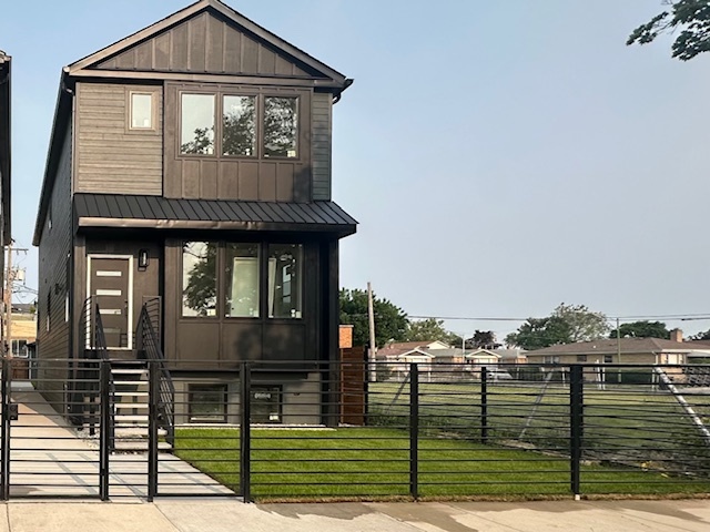 This stunning 5-bedroom, 3.5-bath residence seamlessly blends thoughtful design with luxury finishes. Enjoy custom cabinetry, walk-in custom closets, and quartz countertops throughout. The open floor plan is enhanced by 4-inch wide oak hardwood floors, solid core doors, and soaring ceilings-10 feet on the main level, 9 feet upstairs, and 9 feet in the fully finished basement. A sleek electric fireplace adds warmth and modern elegance to the main living space. Designed for both comfort and energy efficiency, the home includes spray foam insulation and two separate HVAC systems. The exterior showcases James Hardie siding in a striking black-and-white modern farmhouse aesthetic, highlighted by a metal roof over the front porch and upper-level bay window. A fully fenced front yard adds both curb appeal and privacy. Note: The white exterior property at 2844 N Sayre house is already under contract. This black exterior property is available and just a few weeks from completion-with your choice of final finishes guided by our interior designer, allowing you to personalize this dream home to your style.