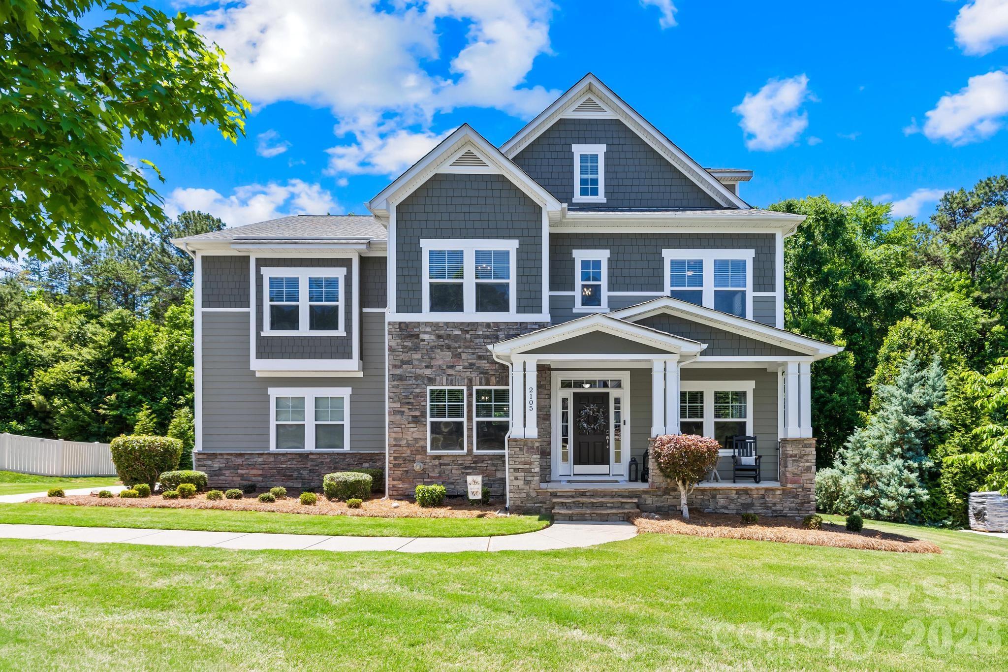 Extensively updated and thoughtfully redesigned, this stunning Tuscany home combines timeless architecture with elevated modern finishes throughout. Situated on a private 0.78-acre wooded lot, this 6-bedroom, 5-bath home offers over 4,000 square feet of refined living space with exceptional attention to detail at every turn.Since 2017, the sellers have transformed the home with wide-plank flooring, designer lighting, fresh interior paint, custom moldings, updated fixtures, and professionally curated finishes that create a clean, cohesive luxury feel throughout. The remodeled kitchen serves as the centerpiece of the home with quartz countertops, updated backsplash details, stainless appliances, double wall ovens, gas cooktop, and a striking oversized island with custom navy cabinetry. The open floor plan flows seamlessly into the spacious family room featuring a floor-to-ceiling stone fireplace, extensive molding details, and expansive backyard views.Additional highlights include a redesigned executive office with French doors, elegant formal dining room, oversized second-floor bonus room, and a private third-floor guest suite with full bath ideal for guests, multigenerational living, or a separate retreat space. The luxurious primary suite features tray ceilings, custom molding, updated flooring, dual quartz vanities, soaking tub, oversized shower, and a generous walk-in closet.Outdoor living is equally impressive with an expansive covered deck overlooking a custom fire pit and private wooded backdrop rarely found in neighborhood living. Located in the highly sought-after Tuscany community with top-rated Union County schools, this home also offers convenient access to shopping and dining in Wesley Chapel, downtown Waxhaw, and I-485 for an easy Charlotte commute.Originally built with impressive architectural detail including tall ceilings, extensive molding, and stone accents, this home has been elevated with the style, warmth, and quality that is certain to please even the most sophisticated buyers.