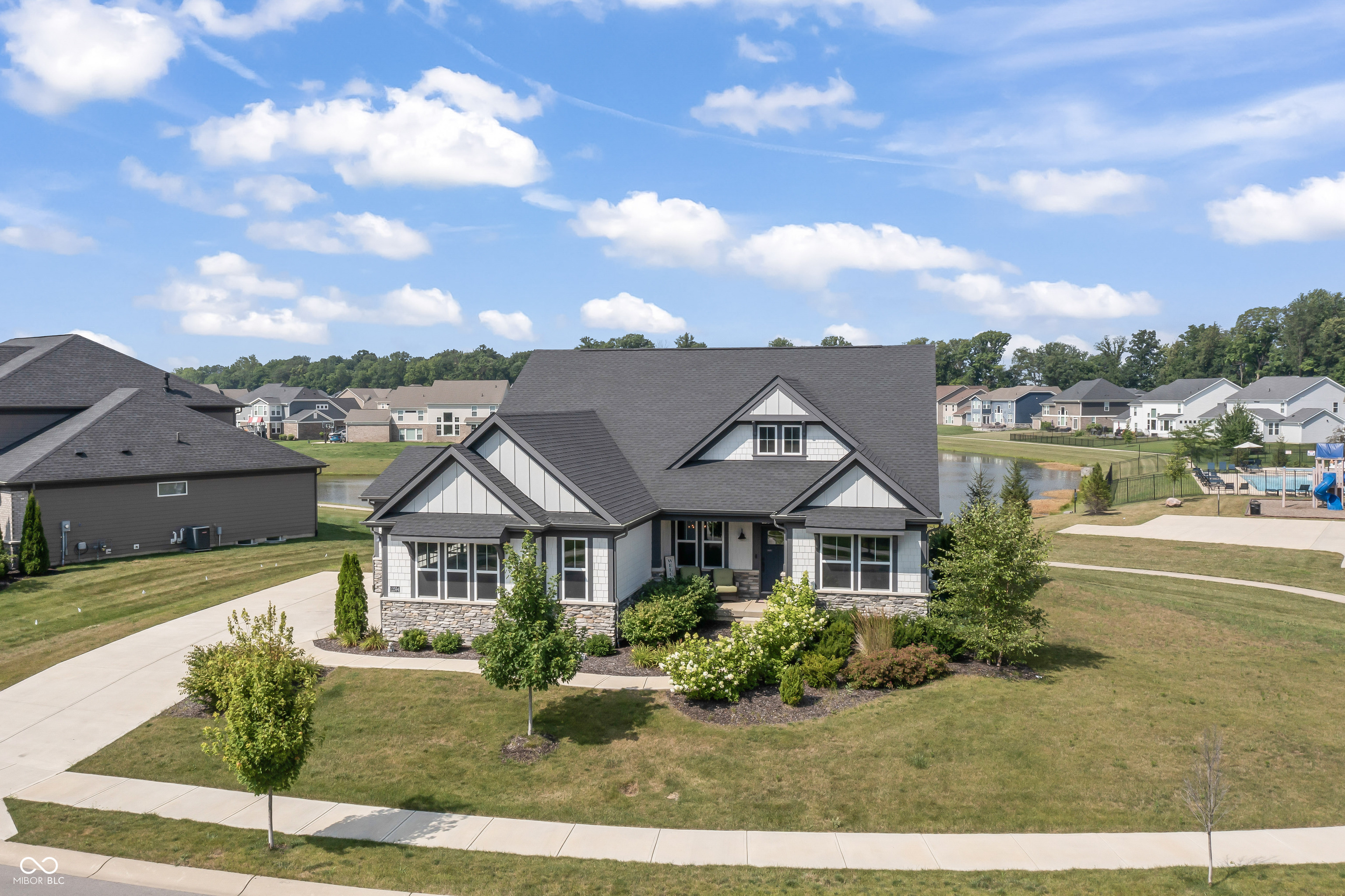 Welcome to 12594 Tidecrest Drive, an exceptional luxury residence in the prestigious Piper Glen community, located within the highly acclaimed Hamilton Southeastern School District. Set on a premium waterfront lot with sweeping pond views, this meticulously maintained 4-bedroom, 3-bath home offers timeless elegance, thoughtful design, and top-of-the-line finishes throughout. The gourmet kitchen is a chef's dream, featuring an oversized quartz island, upgraded stainless steel appliances-including a refrigerator with a craft ice maker-a custom tile backsplash, and abundant soft-close cabinetry. The expansive main living area is designed for both relaxed living and elegant entertaining, with soaring ceilings, floor-to-ceiling windows that capture natural light and serene water views, a remote-controlled gas fireplace, and two separate dining areas perfect for gatherings large or small. Upstairs, a spacious loft provides a private retreat ideal for movie nights, a home office, or guest accommodations, complete with its own bedroom and full bath. The full basement with 10-foot ceilings and plumbing rough-ins for a bathroom and wet bar offers endless possibilities for customization and future expansion. Modern technology and comfort are seamlessly integrated throughout the home, including voice-controlled blinds in the main living areas, remote-operated window treatments in the bedrooms, and a whole-home Klipsch audio system with 12 speakers offering individually controlled sound zones. The upgraded HVAC system includes a whole-home humidifier and air purification system for enhanced comfort and air quality. Additional features include a built-in vacuum system, moisture-resistant hardwood flooring, ceramic tile in the bathrooms and laundry room, and a reverse osmosis water filtration system.Enjoy effortless access to community amenities such as a resort-style pool, playground, and scenic walking trails-all just steps from your front door!
