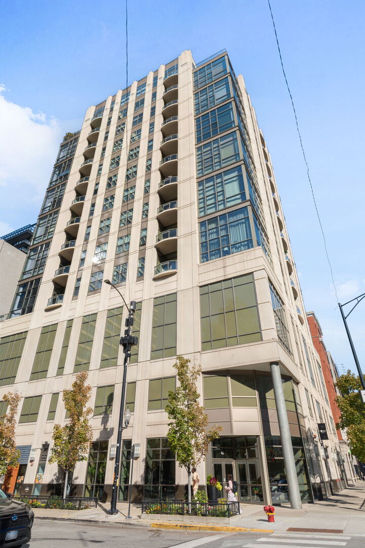 Dramatic River North Duplex with Skyline Views! Soaring 15-foot ceilings, floor-to-ceiling windows, and sweeping northwest skyline views define this stunning duplex home in the heart of River North. Located in a boutique 54-unit doorman/elevator building, the residence offers an ideal blend of volume, light, and modern design. The main level showcases ebony-finished Brazilian cherry hardwood floors, recessed lighting, and a gas fireplace with granite surround. The chef's kitchen features thick granite countertops, undermount sink, tall cabinetry, and commercial-grade Wolf and GE Monogram stainless steel appliances-plus a rare oversized storage loft above. The second bedroom overlooks the living/dining area with a dramatic wall of windows and access to a private balcony. Upstairs, the spacious primary suite comfortably accommodates a king bed and additional furniture, with a walk-in closet and spa-like marble bath with dual vanity and a steam shower. Additional highlights are in-unit laundry and deeded garage parking (offered for an additional fee), a private storage closet, bike storage, and professional management within a well-run association. Unbeatable River North location-just steps from Michigan Avenue, the Riverwalk, East Bank Club, Old Town, CTA trains, parks, and more. Stop Looking. Start Living!