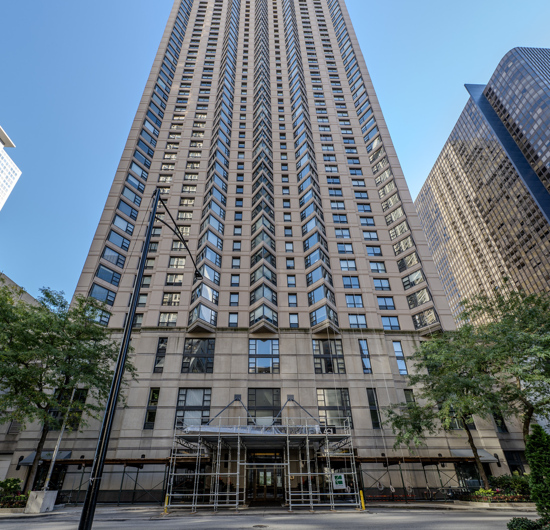 Take in the breathtaking views from this 1850 sq. ft., sun-filled East Corner Unit. Included in the price are 2 premium parking spots, offering added convenience. Enjoy stunning sunrises from this home, situated 40 stories high in the heart of Streeterville. Just one block from the lake and three blocks from Michigan Avenue, you're surrounded by endless activities and experiences.  The open corner layout of the living room provides expansive lake and city views, creating a bright and welcoming space. The dining area flows seamlessly from the living room and connects to the kitchen, forming a spacious and inviting central hub. The kitchen is well-appointed with a brand-new stainless steel refrigerator.  The third bedroom, located just off the main living area, is perfect as a home office, while the second bedroom is down the hall, featuring an organized closet and beautiful views. The second bathroom is conveniently located across the hall from the second bedroom. The master suite includes a generous walk-in closet, a spa-like bathroom with a large walk-in shower.  This is truly the perfect home in the sky. The building offers top-notch amenities, including 5-star service, an event room, two outdoor patios, an indoor pool, a hot tub with views, a fully-equipped gym with a sauna, and a 24-hour doorman. Not to mention, all utilities are included except electric!  This impeccably maintained building is located in a prime Streeterville area, with immediate access to grocery stores, shops, restaurants, coffee spots, bike paths, the beach, Lake Michigan, and more!
