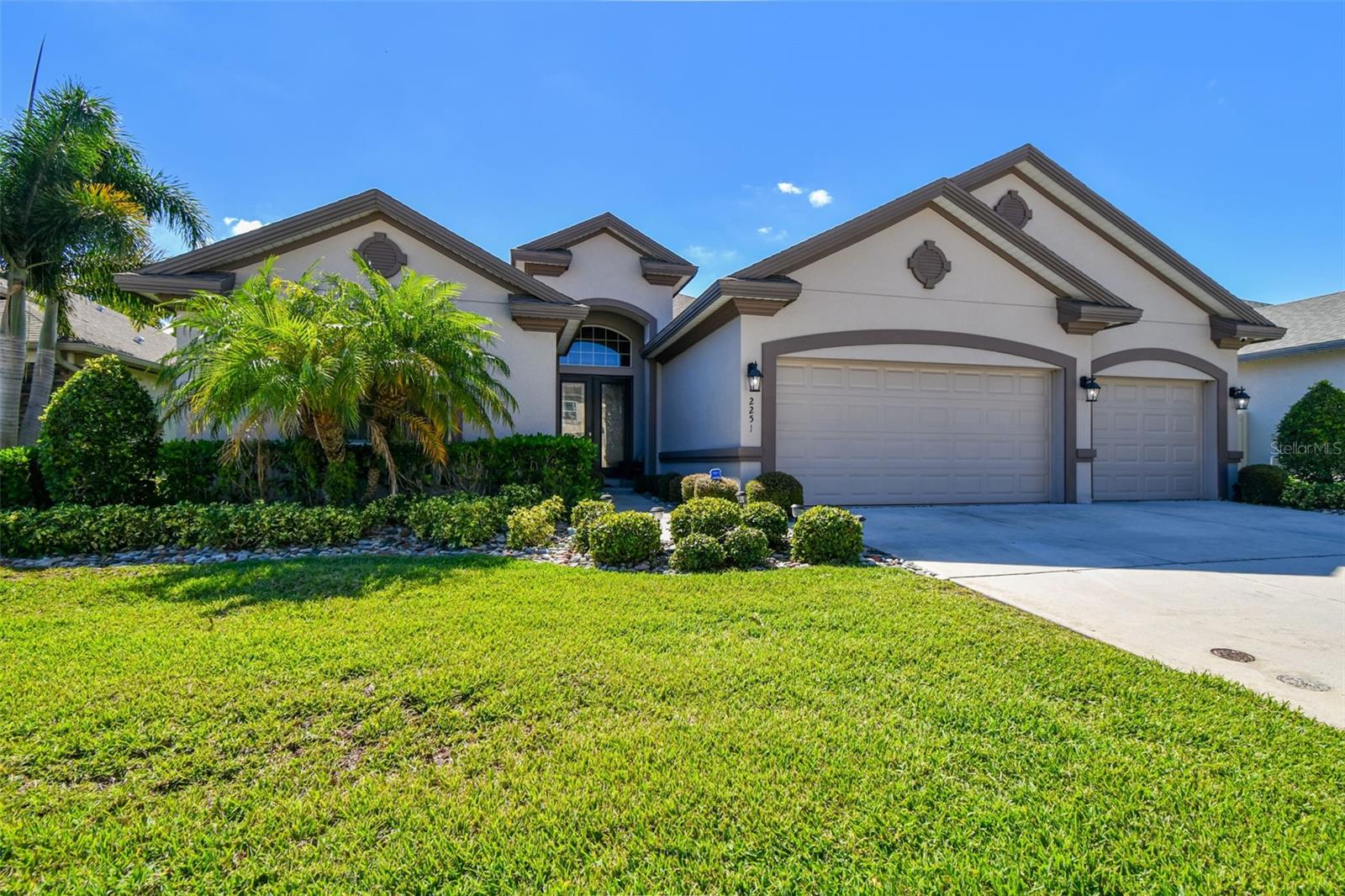 Under contract-accepting backup offers. Located within the private, gated community of Highwood Estates, this 4-bedroom, 3-bath residence blends timeless elegance with modern convenience.  Built in 2018 and lovingly maintained by its original owner, the home spans 2,736 square feet - one of the largest floor plans in this development - with an open, split floor plan designed for both comfortable everyday living and effortless entertaining. A covered front porch and French door entry introduce interiors enhanced by rich wood flooring, detailed crown molding, and refined lighting throughout. The spacious living area features tray ceilings, recessed lighting, and a built-in dry bar with wood cabinetry and sleek black granite, creating a warm, welcoming gathering space. The kitchen is a true centerpiece, outfitted with GE appliances, a gas range, Bosch double-drawer refrigerator and dishwasher, soft-close cabinetry, black granite countertops, and a walk-in pantry. Elegant lighting above and below the cabinets adds to the polished look. A formal dining room offers a dedicated setting for special occasions and family meals. The primary suite enjoys private access to the lanai and pool area, two walk-in closets, and a spa-style bath with separate vanities, a soaking tub, walk-in shower with built-in shelving, and a private water closet. Additional bedrooms include built-in closets and a hall bath with granite counters, while the fourth bedroom doubles perfectly as an office or guest room. The outdoor living space is a highlight, featuring a covered lanai, paver patio, and screened-in pool with three cascading waterfalls and lush landscaping, creating a private retreat ideal for relaxing or entertaining. Practical features include pre-drilled hurricane shutters, Ring doorbell connect, TVs mounts in every room, and both gas and electric connections. The laundry room offers granite countertops, wood cabinetry, a utility sink, and additional closet for ample storage. The 3-car garage is equipped with shelving, a workbench, tankless water heater and water softener system. A rare opportunity to own a meticulously maintained and elegantly designed home in one of the area’s most sought-after gated communities - where quality, comfort, and quiet sophistication come together seamlessly. Ideally located just minutes from top-rated schools, shopping, dining, and charming Downtown Dunedin, with easy access to Tampa International and St. Pete-Clearwater airports. Schedule your private showing today!