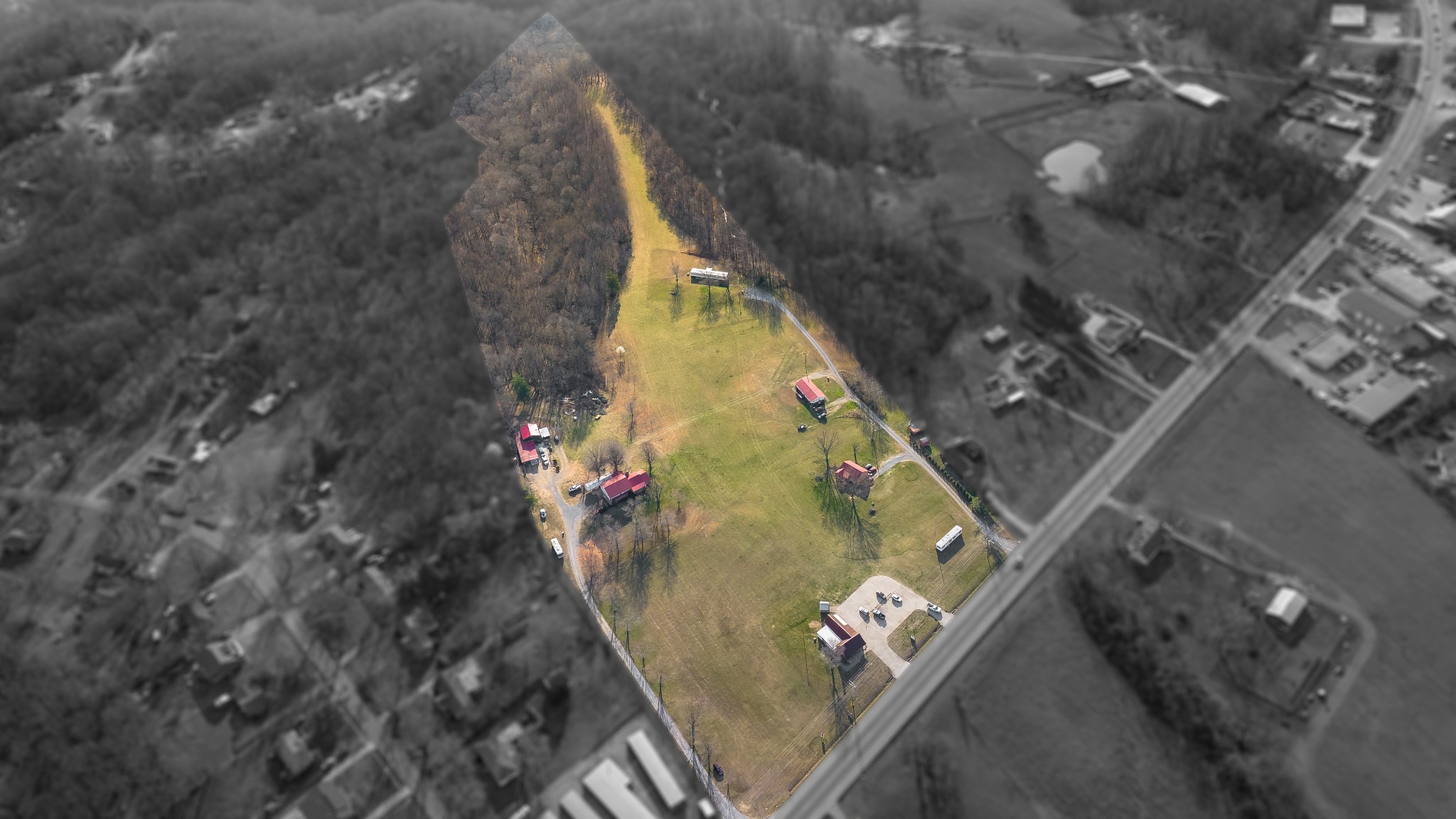 Property to be sold with connecting parcels. Total parcel acreage = 28+/- acres, 3 residential homes, 1 duplex, storage buildings, and the commercial building listed here. Viewings by appointment only meeting at Authentic Coffee. DO NOT Walk the property without appointment. Beautiful land, with large amount of road frontage. Endless possibilities. Currently the houses on this property are rented out, please do not disturb tenants.
