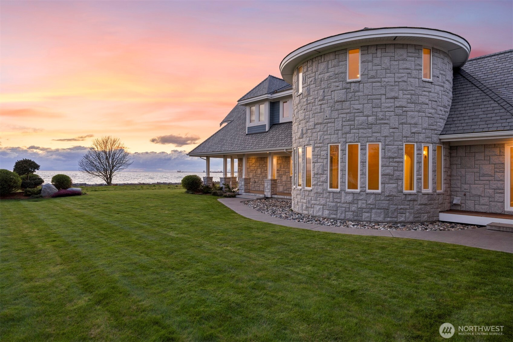 Experience ultimate waterfront luxury in this custom-built estate in Pt. Roberts. Set on 1.3 acres with 152 feet of waterfront, this masterpiece offers sweeping views & exceptional privacy. Every detail was thoughtfully crafted with top-tier materials and finishes. Soaring 22' coffered ceilings, Euroline windows and doors, and Bavaria Russian oak floors exude refined elegance. The gourmet kitchen features Thermador appliances, and a private home theatre provides the perfect escape. Relax in the inglenook by the limestone fireplace or entertain outdoors, enjoying sunsets and marine life. This estate blends timeless design with the natural beauty of the PNW. Don’t miss this rare opportunity to own one of Washington’s premier coastal estates.