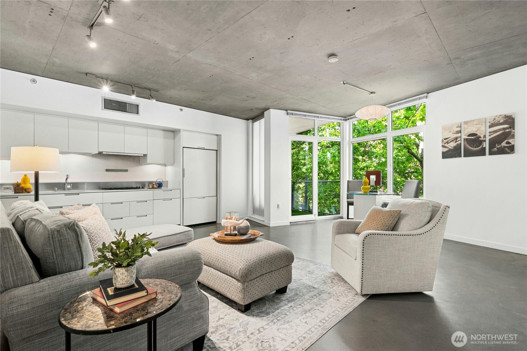 Enjoy the best of Seattle right outside your front door in this sophisticated Lumen loft! Its open layout lives large with integrated living & dining areas flowing around a sleek quartz/stainless kitchen with Euro-inspired cabinets & built-in appliances. Tall ceilings & expansive windows bring in brilliant natural light. Step out and enjoy the scenery from your private balcony, or retreat to your bedroom with built-in wardrobe, stylish 3/4 bath & convenient laundry. Your garage parking space, storage unit, community clubhouse/theater, & BBQ deck are just an elevator ride away. Stroll to South Lake Union business centers, the Seattle Center, Space Needle, & shops/dining galore from this unbeatable location. Great bike & transit access, too!
