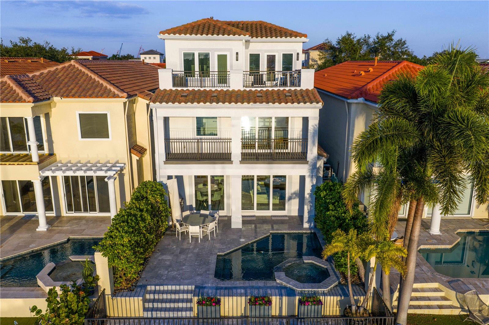 Live where the city meets the water. Welcome home to this fully reimagined single-family home, meticulously renovated top to bottom by renowned Soleil Design. The thoughtful design lives in the fine details. A set of double doors opens to a warm, inviting entryway revealing the home’s showstopping glass elevator and open-concept living space. The chef’s kitchen is a work of art, outfitted with double Wolf ovens, a Wolf six-burner gas cooktop, a Sub-Zero 60" refrigerator, and a separate wine and beverage fridge—your guests will never gohungry or thirsty. High-impact doors and windows flood the space with natural light and frame views of the sparkling PebbleTec pool with AquaLink system, outdoor kitchen with gas grill, and a private boat dock with lift and brand-new seawall. Functional and custom built-ins can be found throughout the home in the family room, office and upstairs. To complete the first floor living space is an office or optional fifthbedroom with adjacent bathroom and the first of two laundry utility rooms. Whether you take the stairs or glide up in the glass elevator, the second and third floors continue to impress. The split floor plan gives the primary retreat a wing to itself, complete with a private balcony overlooking serene water views, a double-vanity bathroom, walk-in closet, and a soaking tub positioned to capture its own waterfrontvista. Additional bedrooms are beautifully appointed, and the second floor features a secondary laundry room for everyday convenience, along with the home’s integrated smart-home systems. Ascend to the third floor and discover a flexible bonus space—perfect as a guest suite with a full bath or an entertainment lounge that opens onto a rooftop deck made for sunset gatherings.Harbour Island’s 24-hour guarded gates ensure serenity, yet you’re mere steps from Tampa’s vibrant Riverwalk, Bayshore Boulevard, Water Street, and the city’s premier arts and dining districts. Commuters appreciate quick access to I-275, the Lee Roy Selmon Expressway, and Tampa International Airport, making every aspect of daily life effortless. Move right in and begin living the waterfront dream you’ve alwaysimagined—sunsets, sailing, and sophisticated entertaining await.