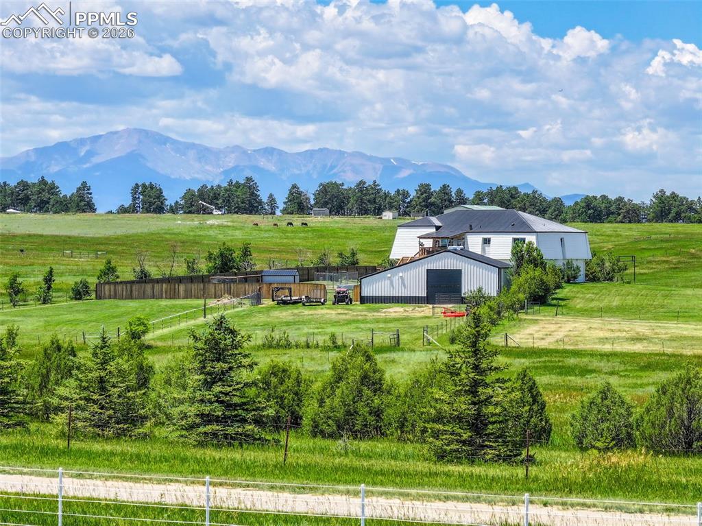 Positioned above the trees so you can truly take in the views, this one of a kind Colorado retreat feels like something out of a hidden homes feature private,unexpected,and nearly impossible to replicate.At the very end of a quiet private road, this 35-acre property with over 2,000 mature trees offers a rare combination of seclusion,usable land, and convenience just minutes from Falcon. Rolling terrain,wide-open skies, and a setting that feels tucked away create the kind of lifestyle people imagine when they think of living in the country.Inside, you’ll find over 3,500 sq ft of thoughtfully designed space with real hardwood floors, custom railings,9-ft ceilings, and triple-pane windows that bring the outdoors in. The kitchen is the heart of the home, featuring a massive island that seats eight, a gas range, and abundant storage, flowing seamlessly into the dining area and living room anchored by a stunning stone fireplace with built-ins.The primary suite feels like its own retreat, tucked up a private staircase with oversized windows, a spa-inspired bath, and a generous walk-in closet. The lower level offers a theater room, additional bedroom and full bath, plus flexible living space ideal for guests, multigenerational living, or a private workspace.Car enthusiasts, hobbyists, and anyone needing real space will appreciate the 1,500 sq ft heated attached garage with RV hookups, clean-outs, water access, and room for multiple vehicles. The 2,300 sq ft shop is equally impressive fully insulated and heated with concrete floors, water, and 400-amp service.Outside, the property truly shines with six fenced and cross-fenced pastures, healthy hay grass, a custom chicken coop, and a privacy-fenced backyard. A private trail winds through the land, making it easy to explore, ride, or simply enjoy the setting.Modern comforts are already in place, including 2-gig fiber internet, A/C, two water heaters, a newer furnace,and water softener/filtration system.If you’ve been searching for a property that offers privacy, space, and a lifestyle that’s increasingly hard to find,this is it.