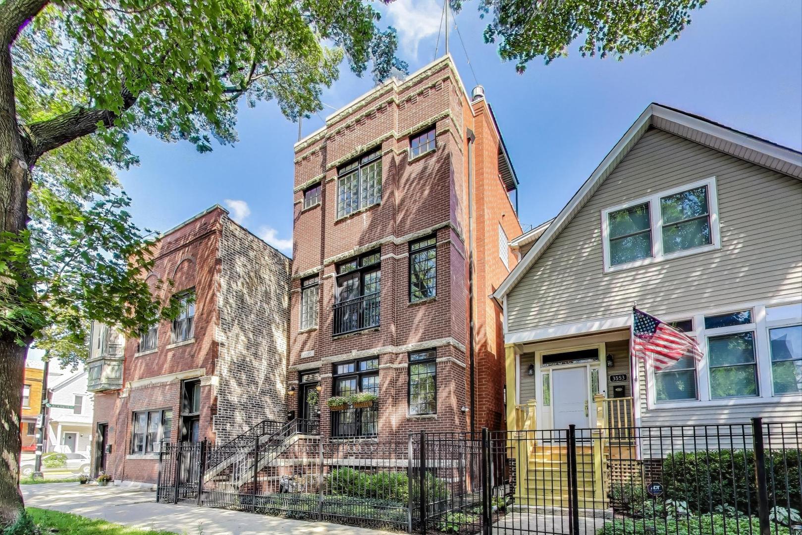 Welcome to 3555 N Marshfield Avenue, a stunning 3-bedroom, 2.5-bath duplex down in an intimate, all-brick, two-unit building. Perfectly situated within the highly sought-after Hamilton School District, this spacious residence offers the feel of a single-family home in one of Chicago's most desirable locations. Just steps from the Southport Corridor and Roscoe Village, this boutique home blends exceptional design, comfort, and convenience. The residence showcases a thoughtfully designed floor plan tailored for modern living, complemented by a private deck, a landscaped yard for outdoor enjoyment, and a spacious garage providing both convenience and abundant storage.  The main level offers a seamless blend of formal and casual living, featuring a sun-filled living and dining room, a spacious family room, and a beautifully updated kitchen designed with today's most desirable finishes. Large windows, rich hardwood floors, and a cozy gas fireplace create a warm and inviting atmosphere. The chef's kitchen is appointed with premium appliances-including a Sub-Zero refrigerator, Viking range, and Bosch dishwasher-along with white cabinetry, quartz countertops, a Kohler farmhouse sink, and a striking chevron tile backsplash. Extending the living space outdoors, a private patio opens from the family room, with easy access to the generously sized backyard.  The lower-level features 3 spacious bedrooms and 2 full baths, including a primary suite with professionally organized walk-in closet, an ensuite bathroom featuring double sinks and a separate tub and shower with multiple body sprays and steam. The 2nd and 3rd bedrooms share a Jack-and-Jill bathroom and feature large fully organized closets. Custom window treatments throughout, including blackout shades in bedrooms. Garage parking and additional storage included. Steps to Southport Corridor, Roscoe Village, restaurants, shops, parks, the brown line, and multiple grocery stores. Welcome Home!
