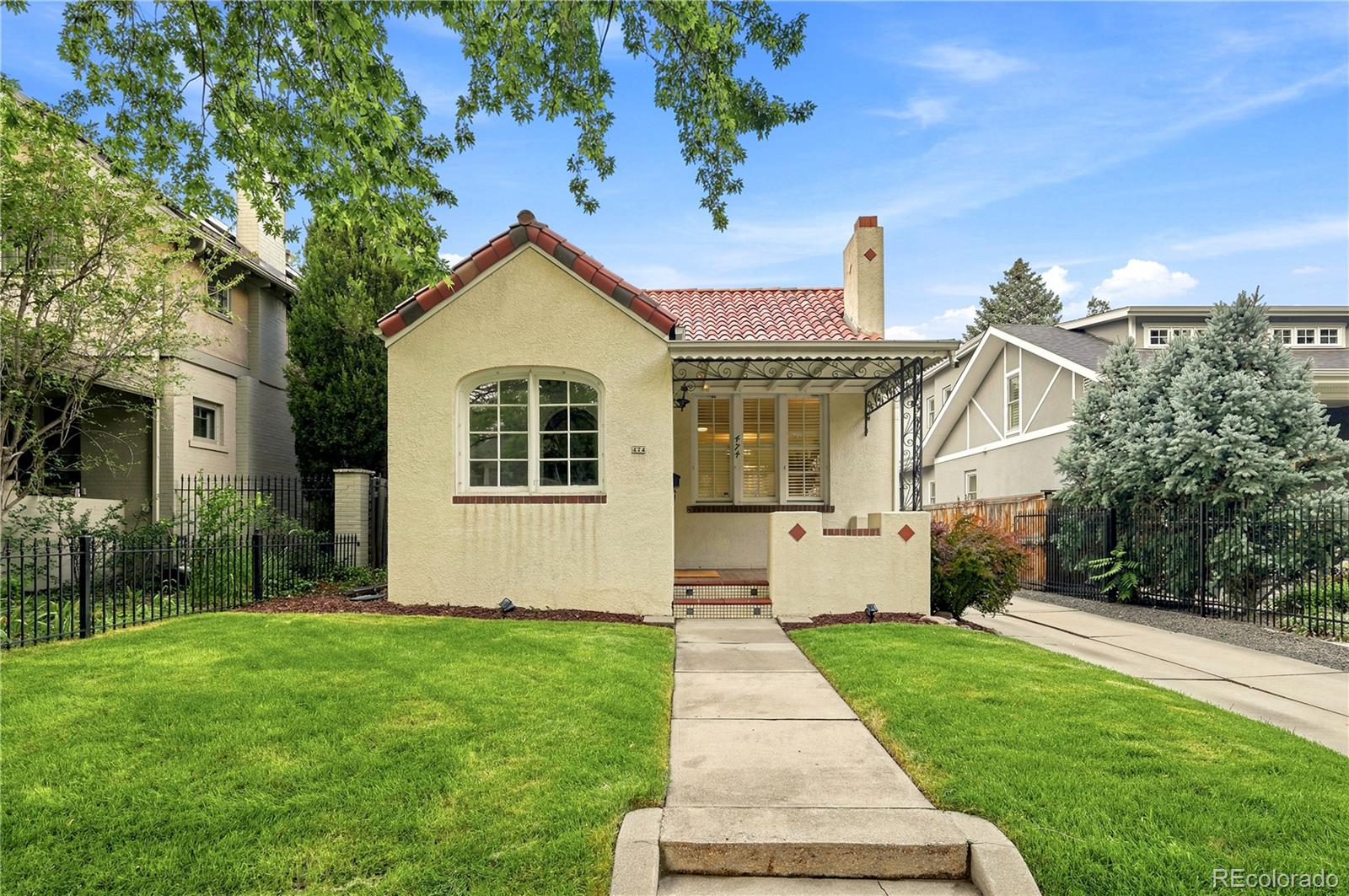 Nestled on a quiet, tree-lined block in Denver's coveted Country Club neighborhood, this charming Spanish-style home combines timeless character with thoughtful updates in one of the city's most desirable locations. Hardwood floors, abundant natural light, and a beautiful fireplace create warm and inviting living spaces throughout.The updated kitchen features quartz countertops, hardwood floors, and modern appliances, while the finished lower level provides valuable additional living space with a spacious family room, full bathroom, laundry area, storage, and flexible guest, office, or recreation space. This 3-bedroom, 2-bath home offers approximately 2,040 square feet of living space, a detached one-car garage, and beautifully landscaped front and back yards. Recent improvements include fresh main-floor paint, new front-yard sod, and a new boiler.The backyard offers a private and inviting outdoor retreat with a lawn, patio space, and room for entertaining, outdoor dining, gardening, or simply enjoying a quiet morning coffee or evening at home. Thoughtfully designed as an extension of the home's living spaces, it provides a peaceful setting for both everyday enjoyment and gathering with family and friends.Located within the highly regarded Bromwell Elementary boundary, this exceptional residence offers easy access to Cherry Creek's premier shopping, dining, and entertainment while enjoying the tranquility of a residential block removed from the immediate construction activity. Conveniently located near Congress Park, Cheesman Park, Cherry Creek North, and Downtown Denver, this is a rare opportunity to own a distinctive home in one of Denver's most sought-after neighborhoods.