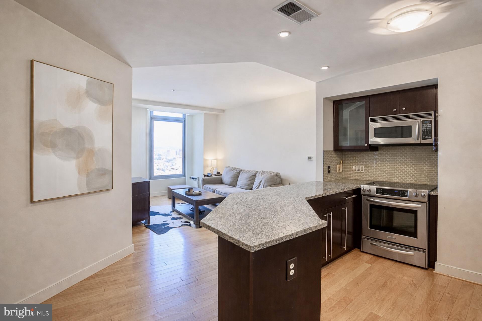 Experience elevated city living at The VUE in the heart of Harbor East. This  one-bedroom, one-bath condo features Large windows for natural lighting and views, new hardwood floors, and a modern kitchen with granite countertops and stainless steel appliances. The bathroom offers a spacious walk-in shower. Enjoy the convenience of in-unit laundry with a brand-new washer and dryer.Enjoy full-service luxury with 24-hour security, concierge Monday-Saturday, secure package delivery, and one deeded covered parking space. Residents have access to premium amenities including a dog park, EV charging, bike storage, and direct access to Harbor East Cinemas and the Coppermine gym (membership required).Step outside to Baltimore’s most vibrant neighborhood—just moments from top dining, boutiques, Whole Foods, Starbucks, the waterfront promenade, and Water Taxi. With easy access to downtown, stadiums, Johns Hopkins, Penn Station, and BWI, this is ideal city living with convenience.